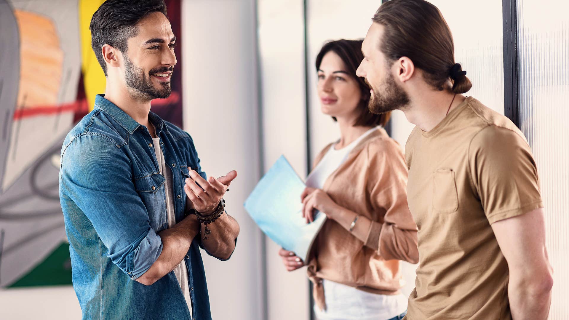 man speaking respectfully to co-workers in office
