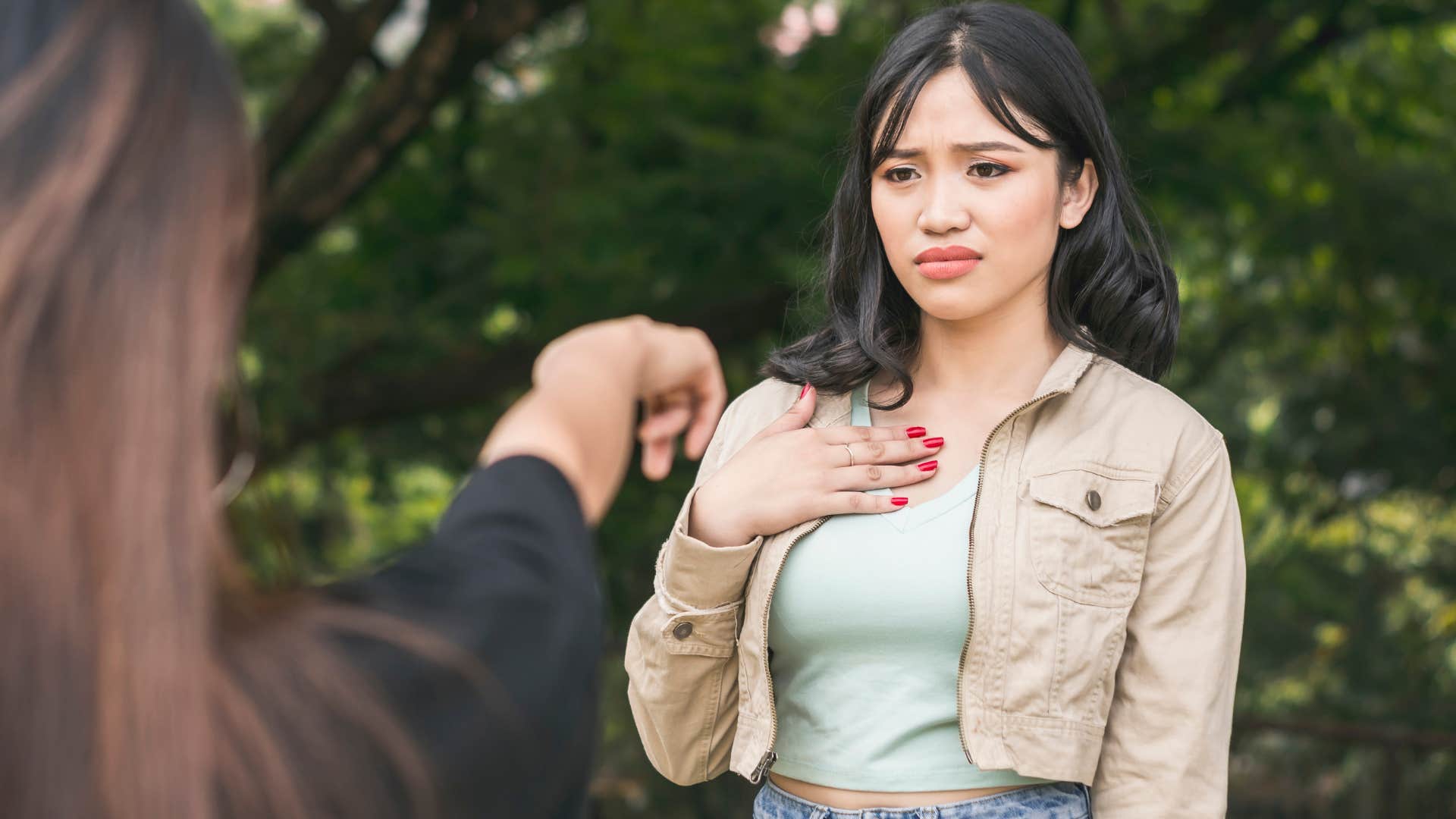 Woman who never apologizes looking annoyed outside.
