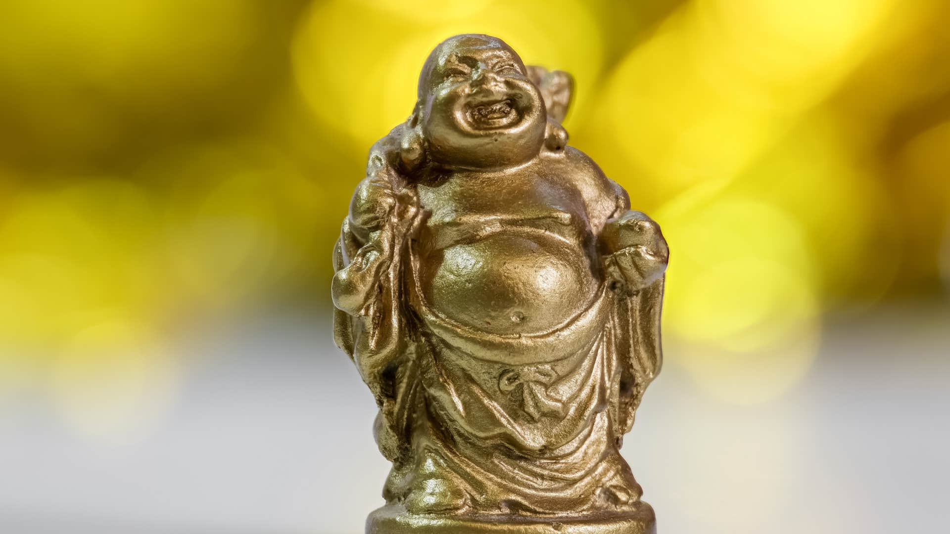 laughing buddha statue that is a spiritual habit that will help others feel better off