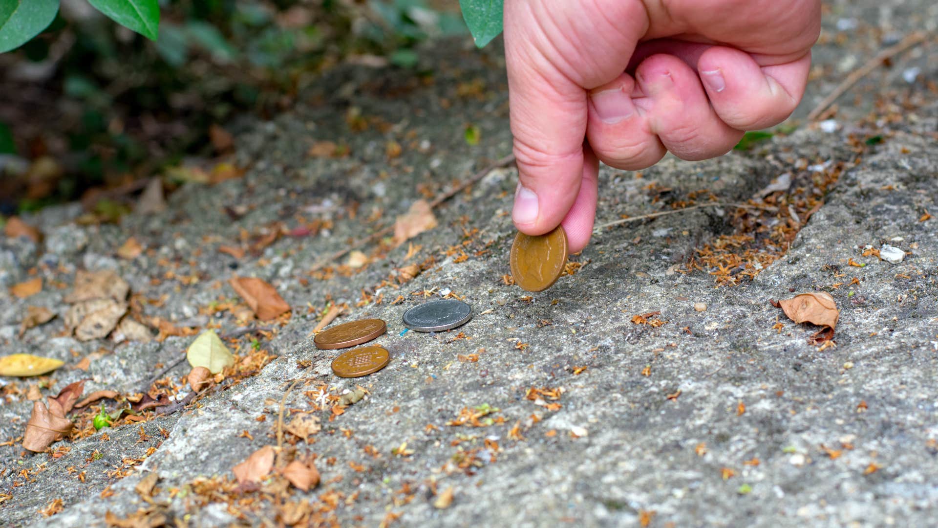 man who wants to feel better off by picking up pennies