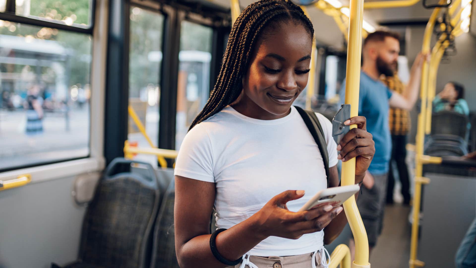 Woman who commutes responsibly standing in the train.
