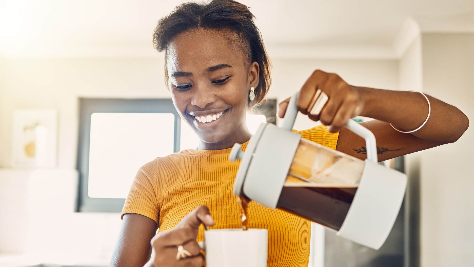 Woman making their own coffee at home.