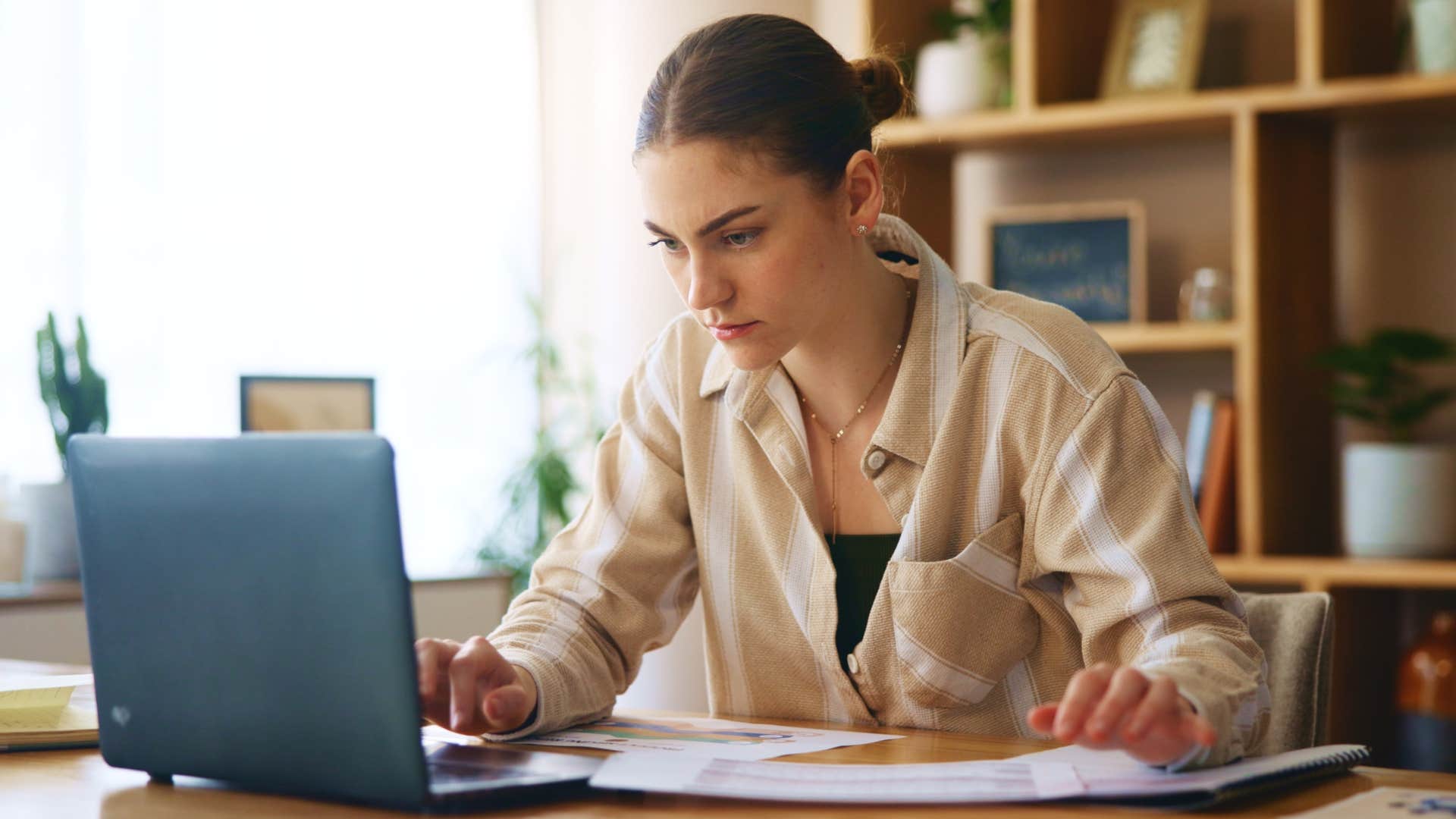 Woman who quietly budgets working on her computer.