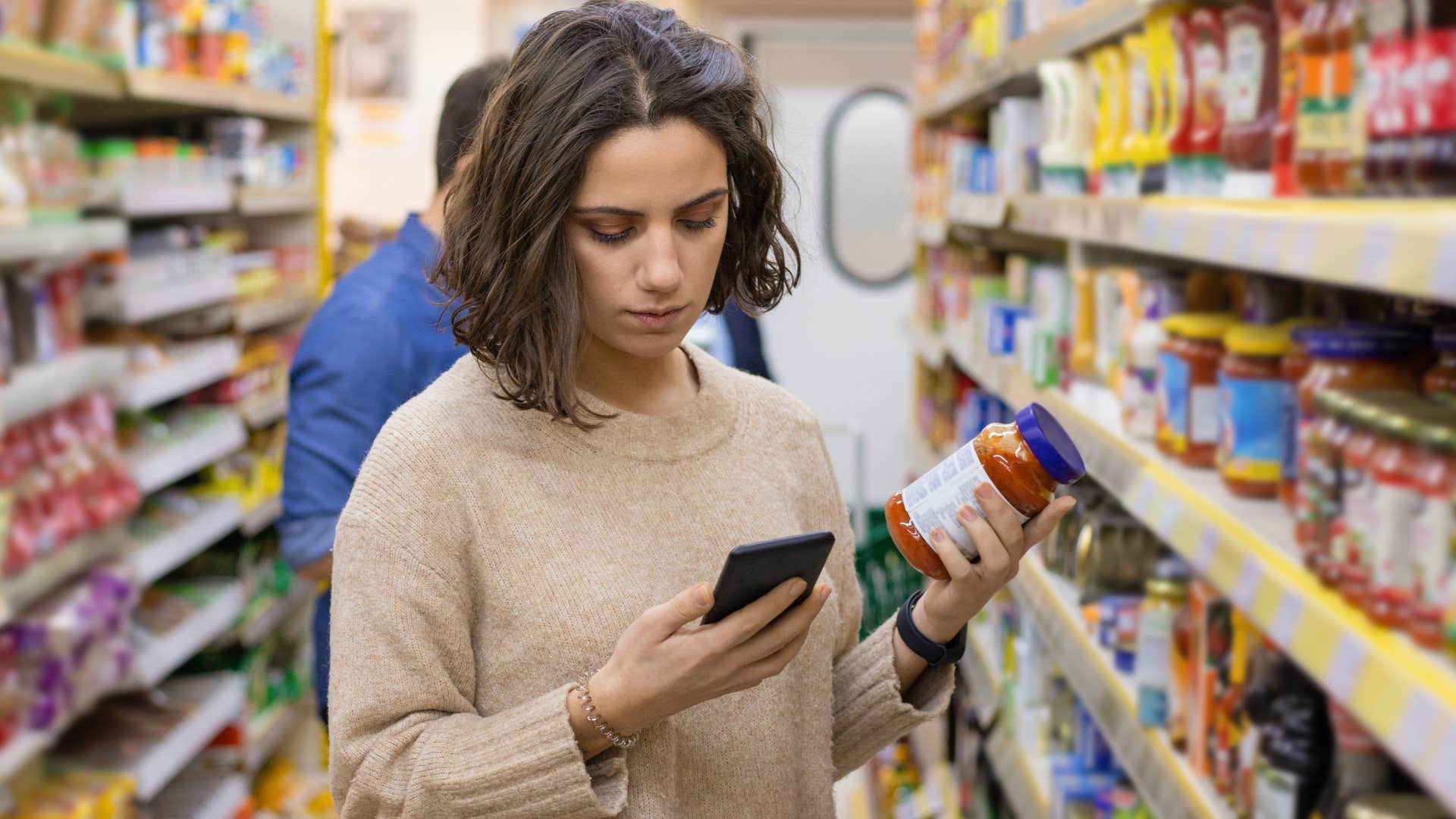 Woman who only shops for quality items standing in a grocery store.