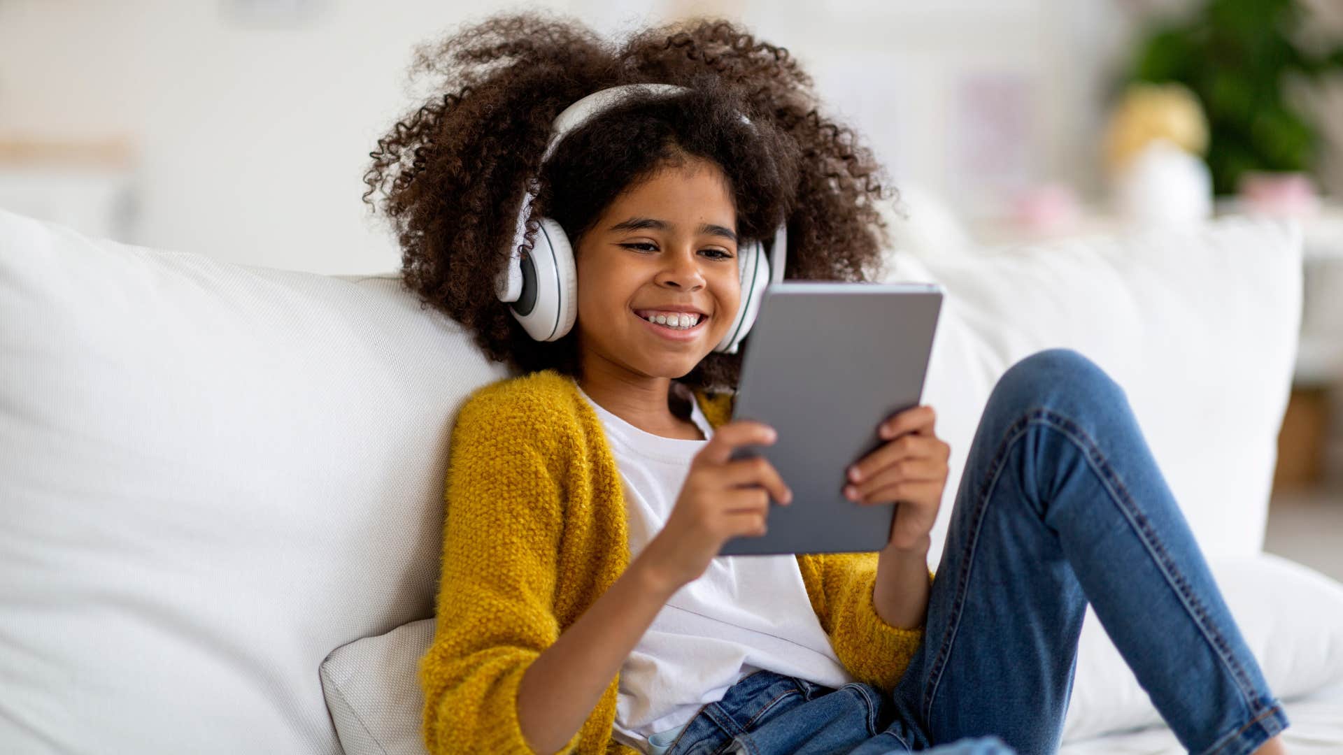 little girl playing on tablet
