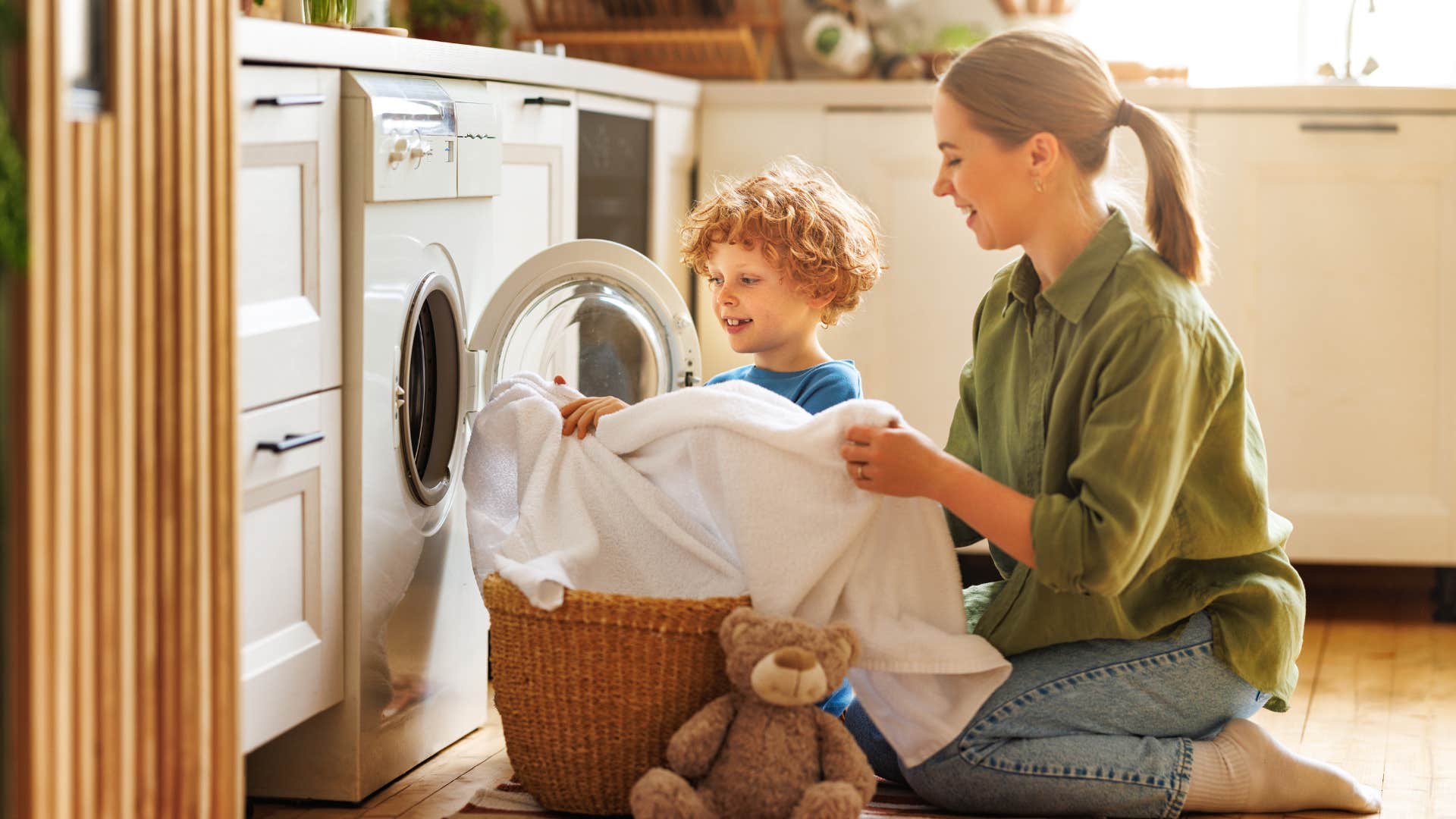 mom teaching son how to do laundry