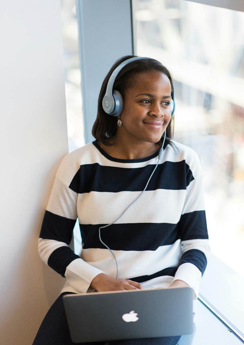 woman listening to music in the background while working