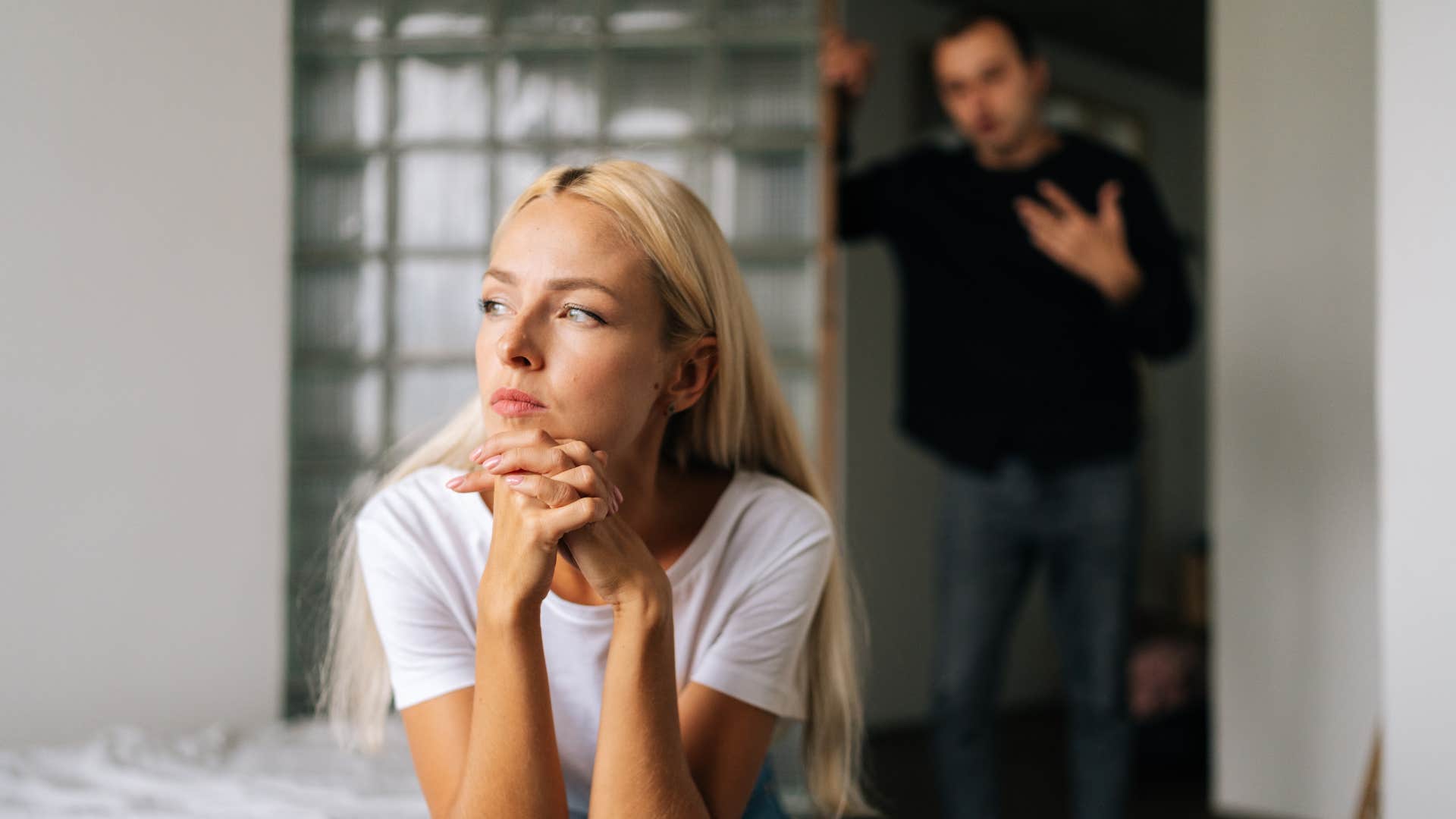 woman keeping score and holding grudges as she ignores man at door