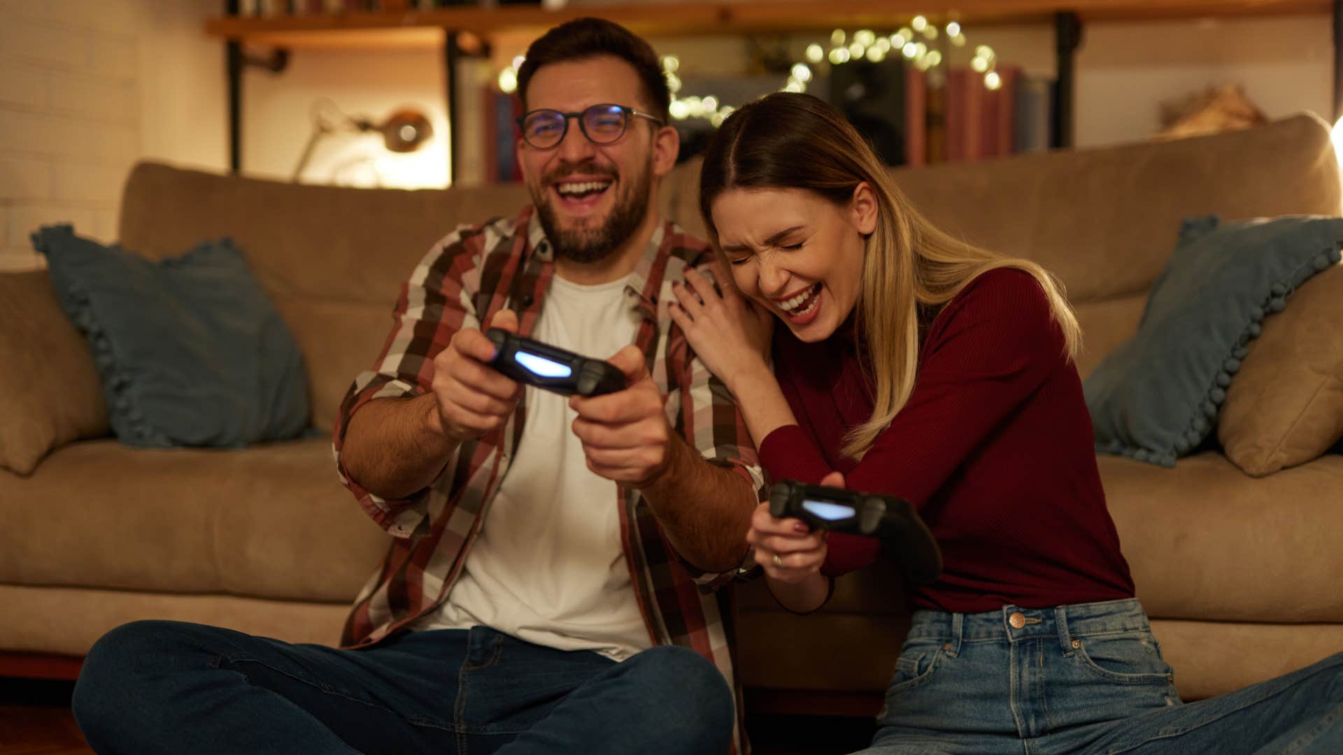 woman in red shirt showing interest in man's hobbies as they play games