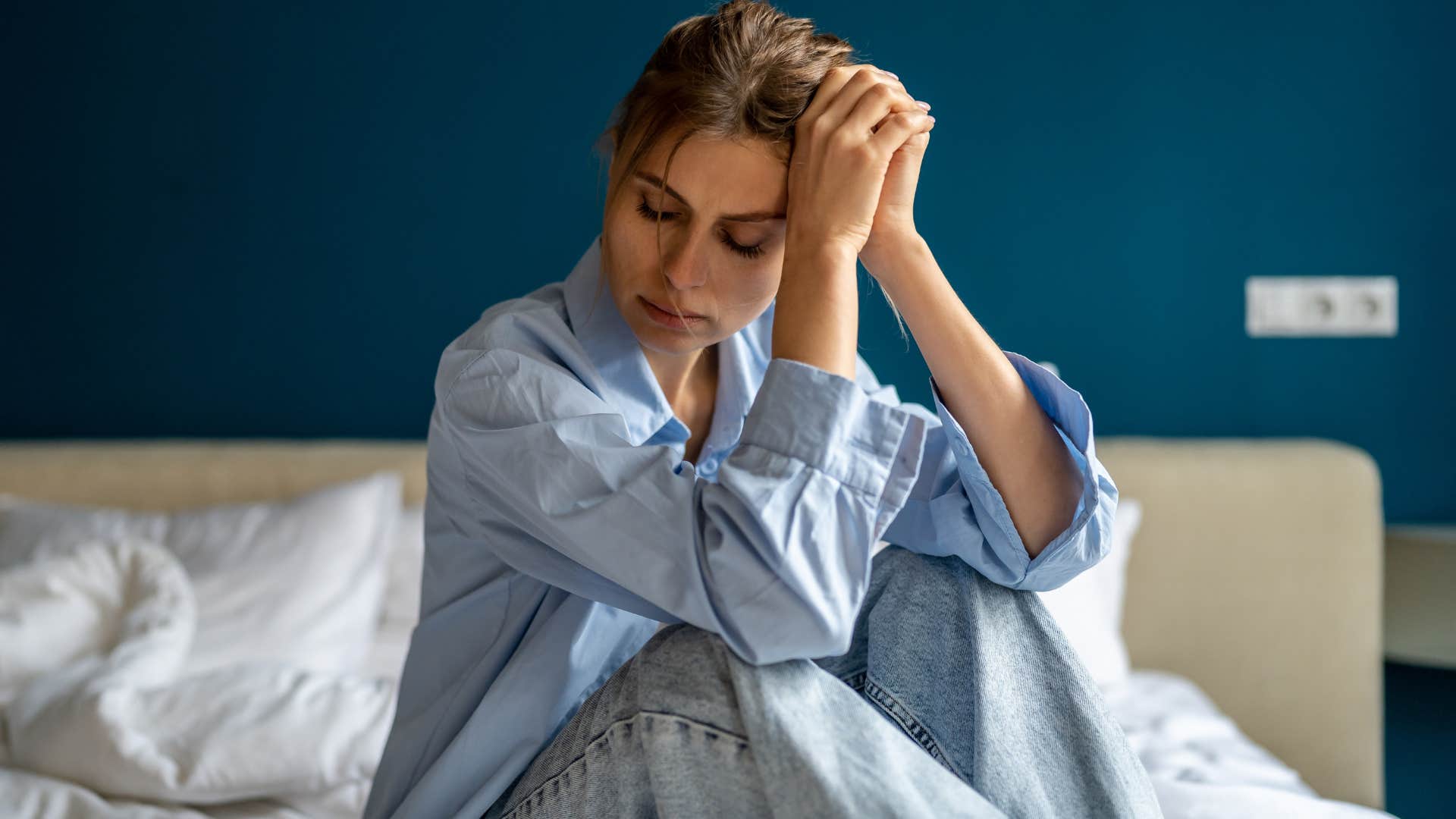 Woman who can spend more time alone sitting in bed.