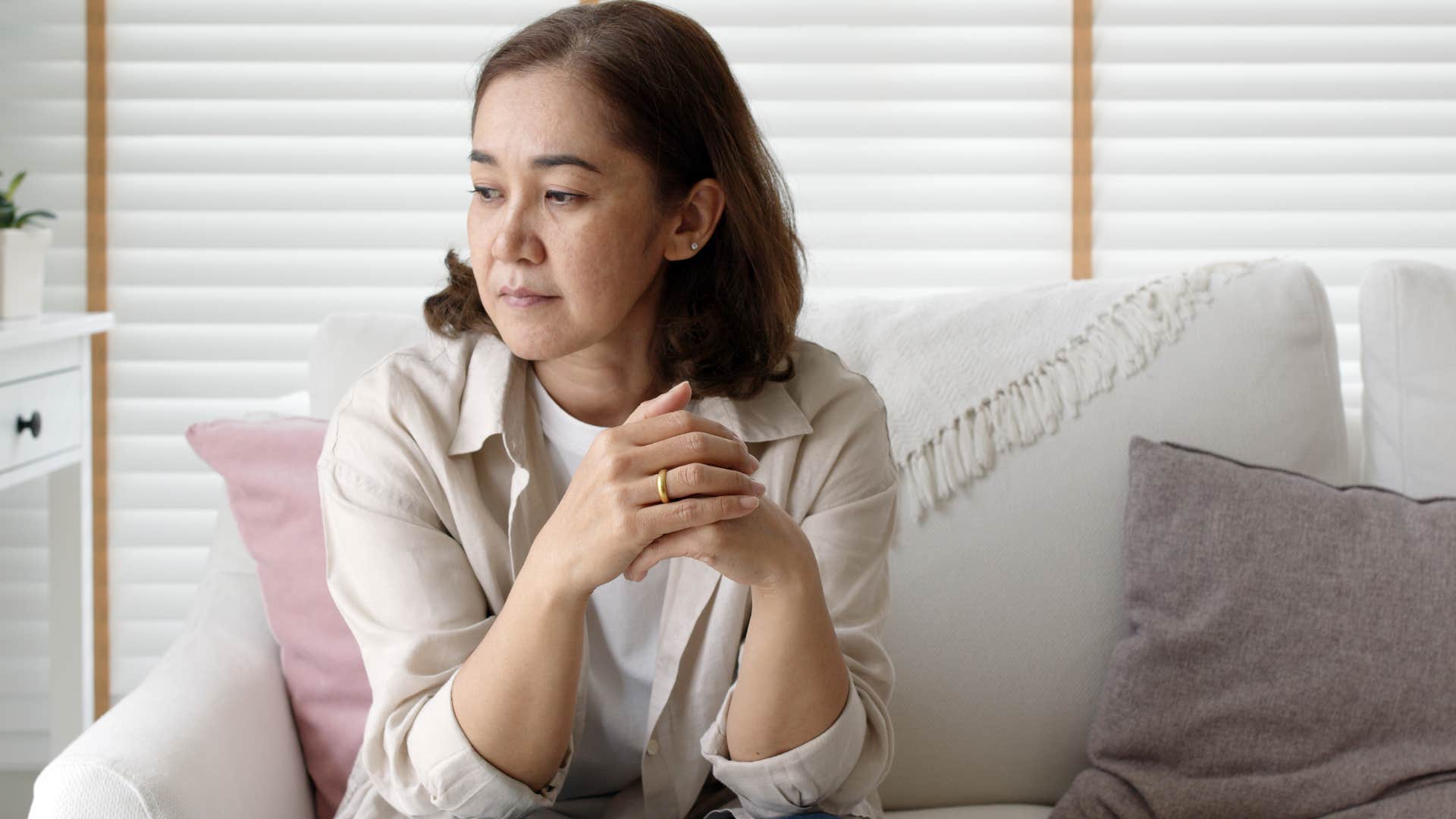 Woman who's stopped taking on all the chores sitting on the couch.