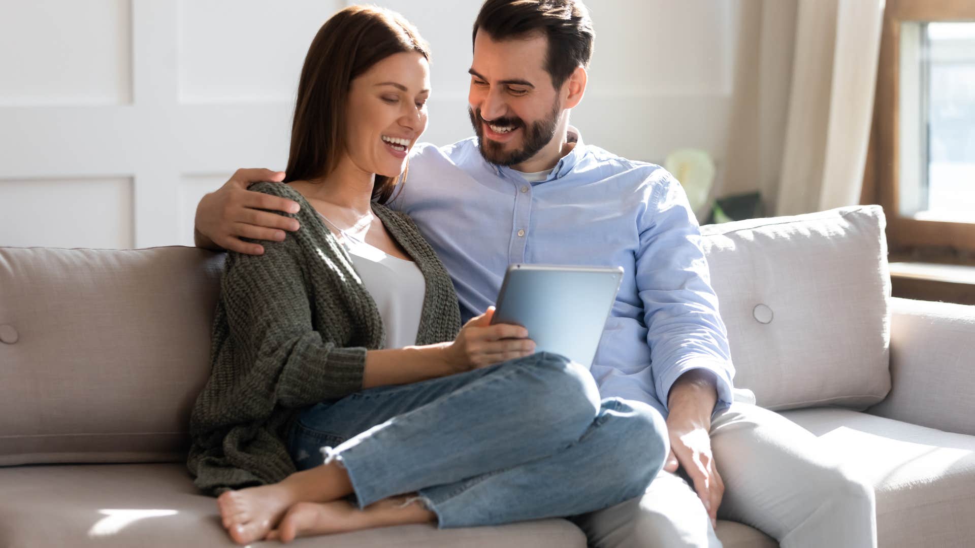 wife and husband having conversation together on couch