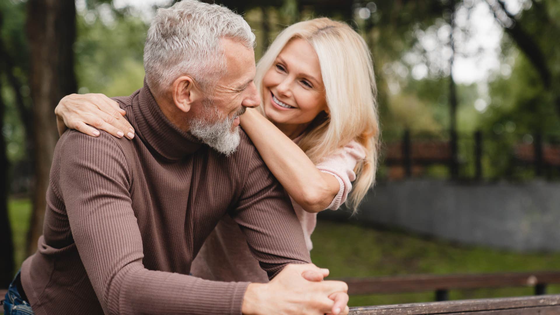 Man saying "I'm proud of you" to his wife outside.