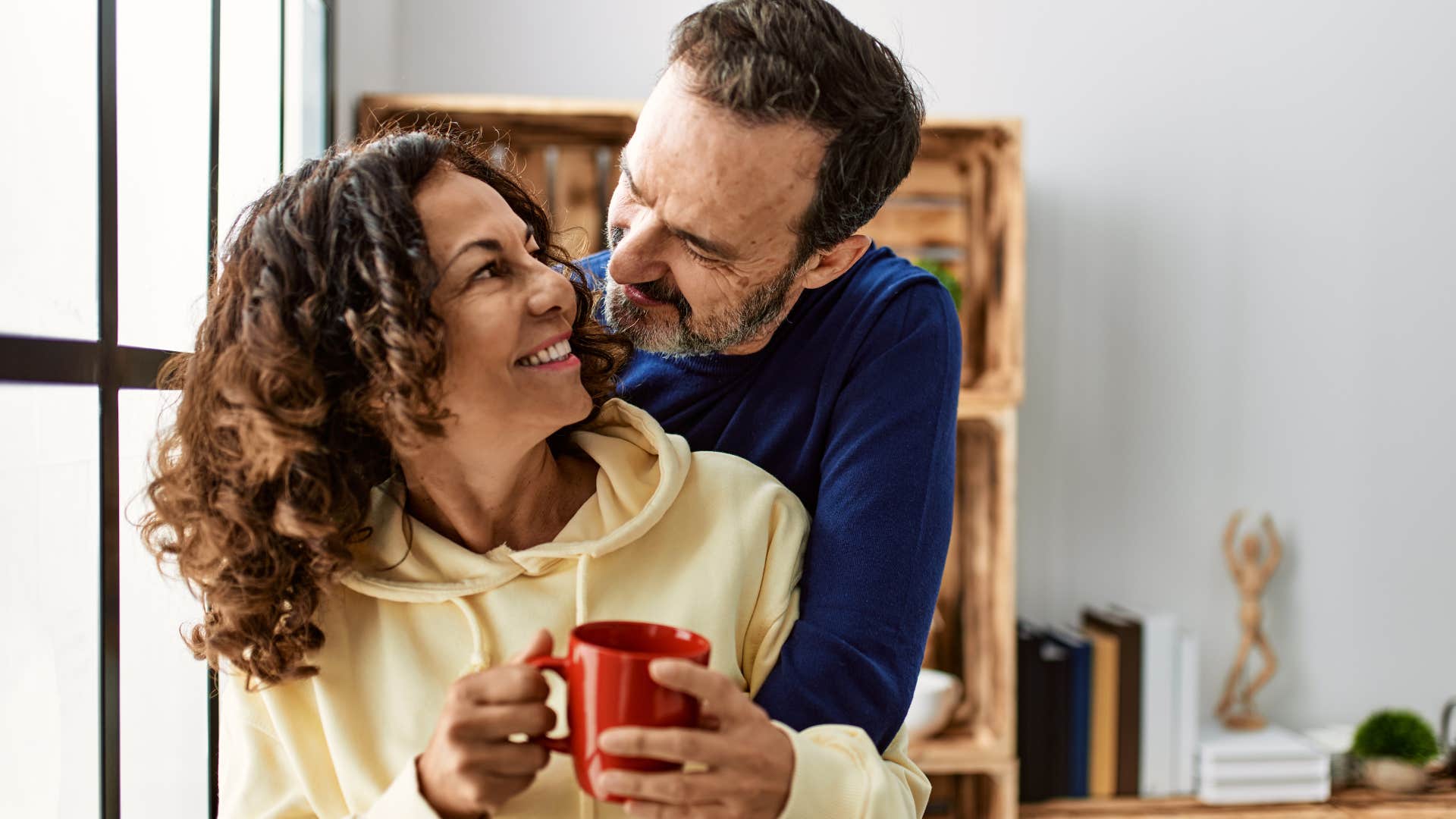 Man asking "What can I do better?" while hugging his wife.