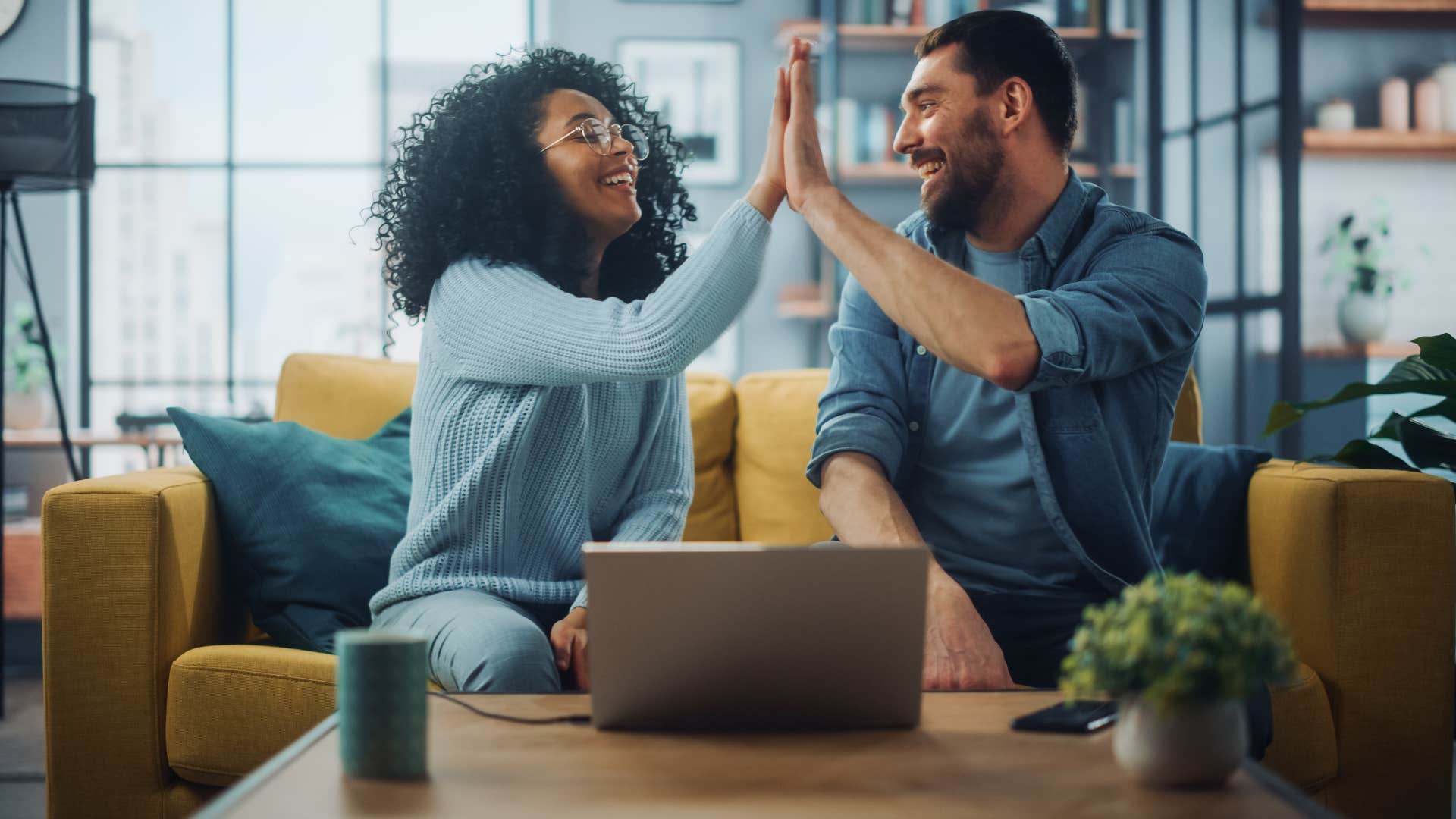 woman high fiving man as they agree to make sacrifice without resentment