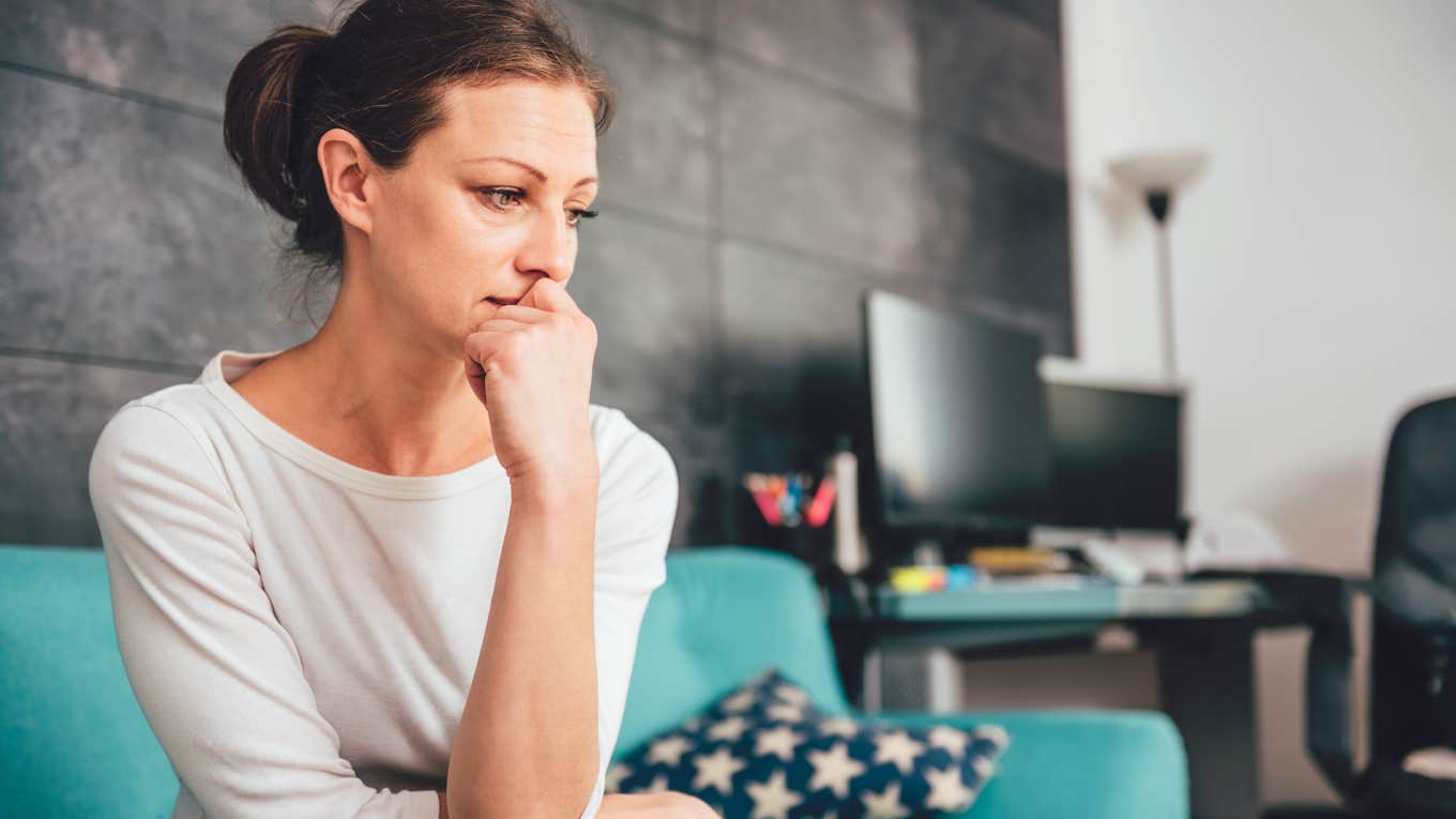 Woman Who Can't Marry Her Boyfriend Asks How To Reassure His Kids She's Not Going To Leave Them upset and depressed woman sitting on couch