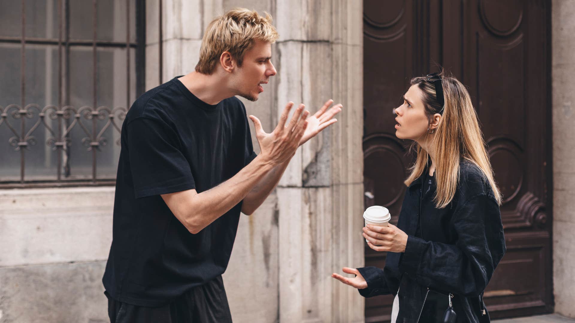 man arguing with woman as woman in public