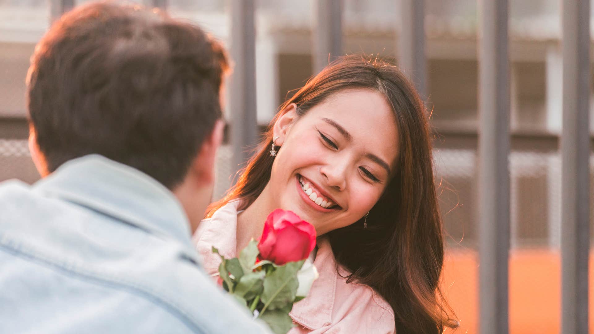 a husband gifts his wife a flower showing his affection for her