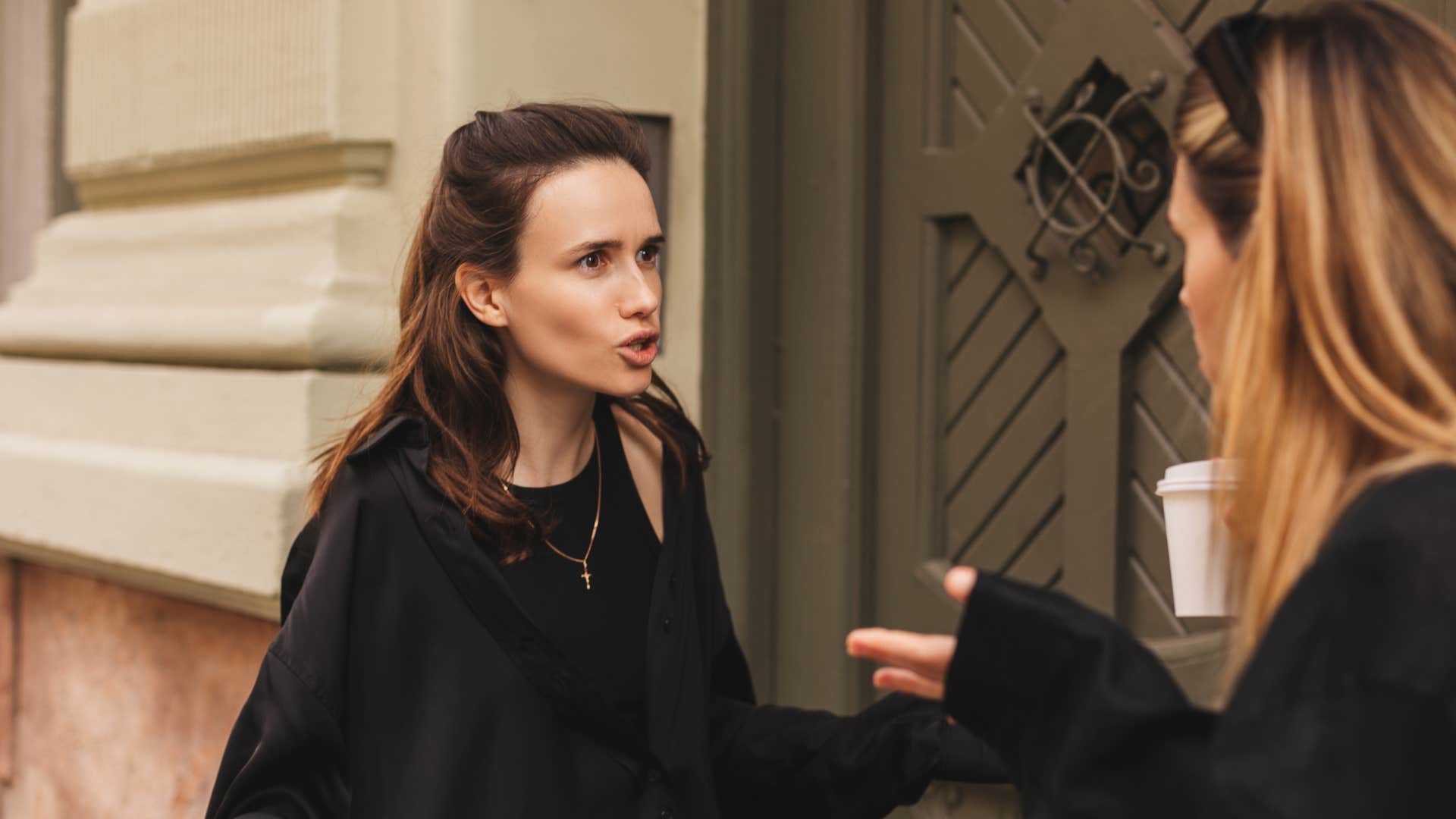 friend in black outfit saying it was just a joke as other friend looks offended