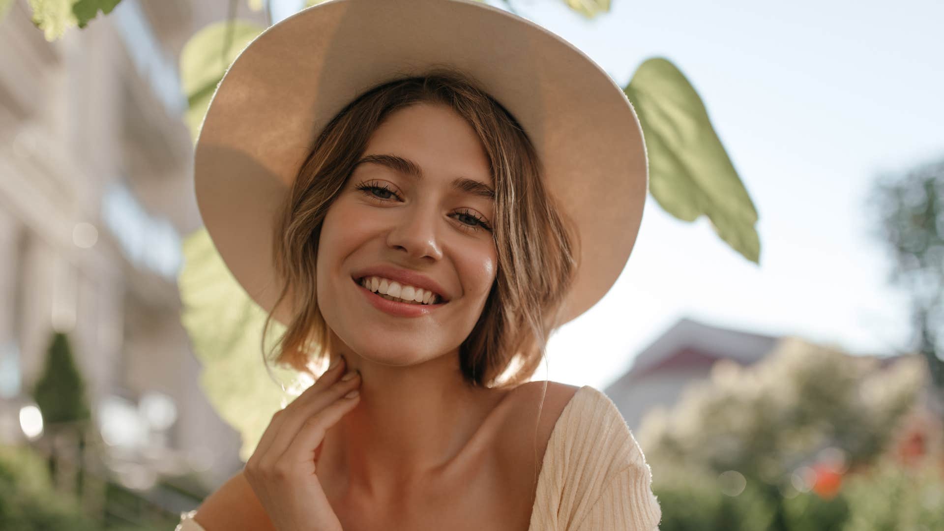 a woman goes outside in small amounts and wears hats to protect herself