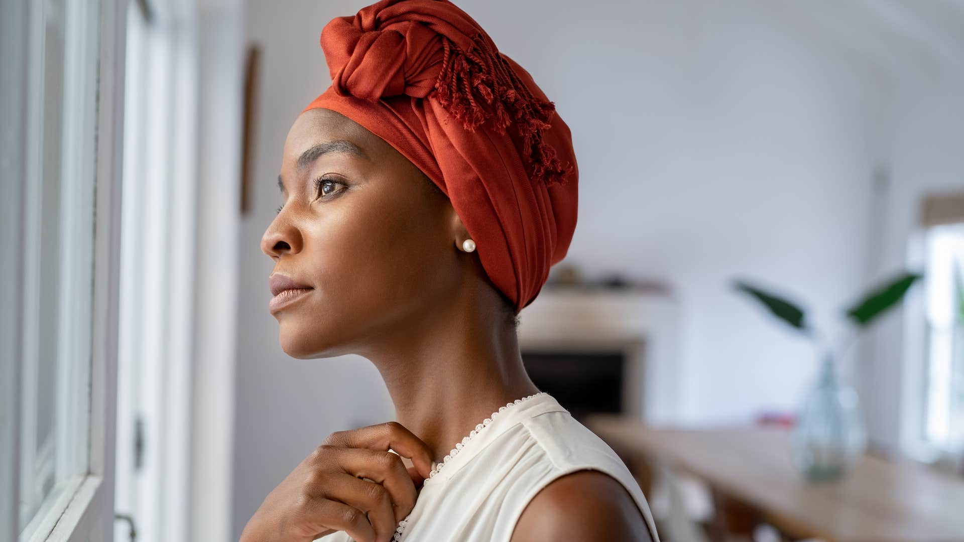 Woman who can spend more time alone looking out a window.