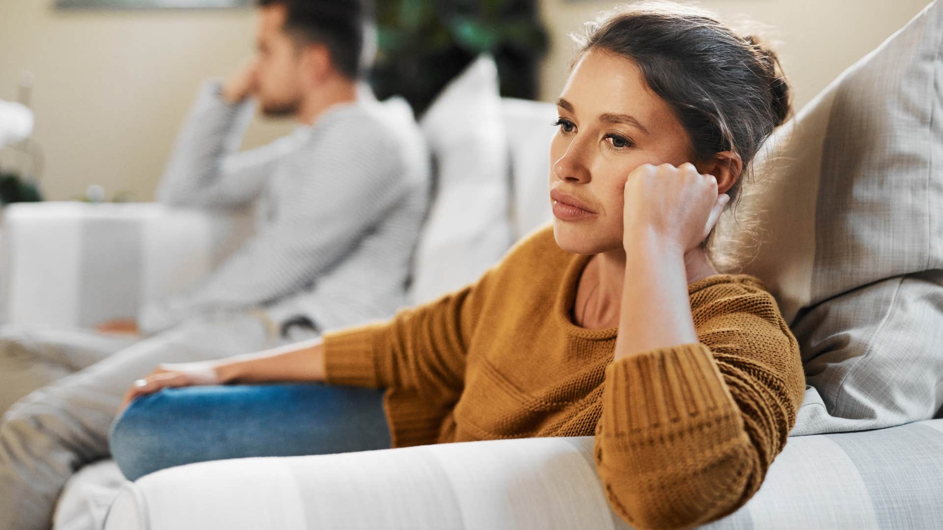 woman who gets overly defensive turned away from her husband