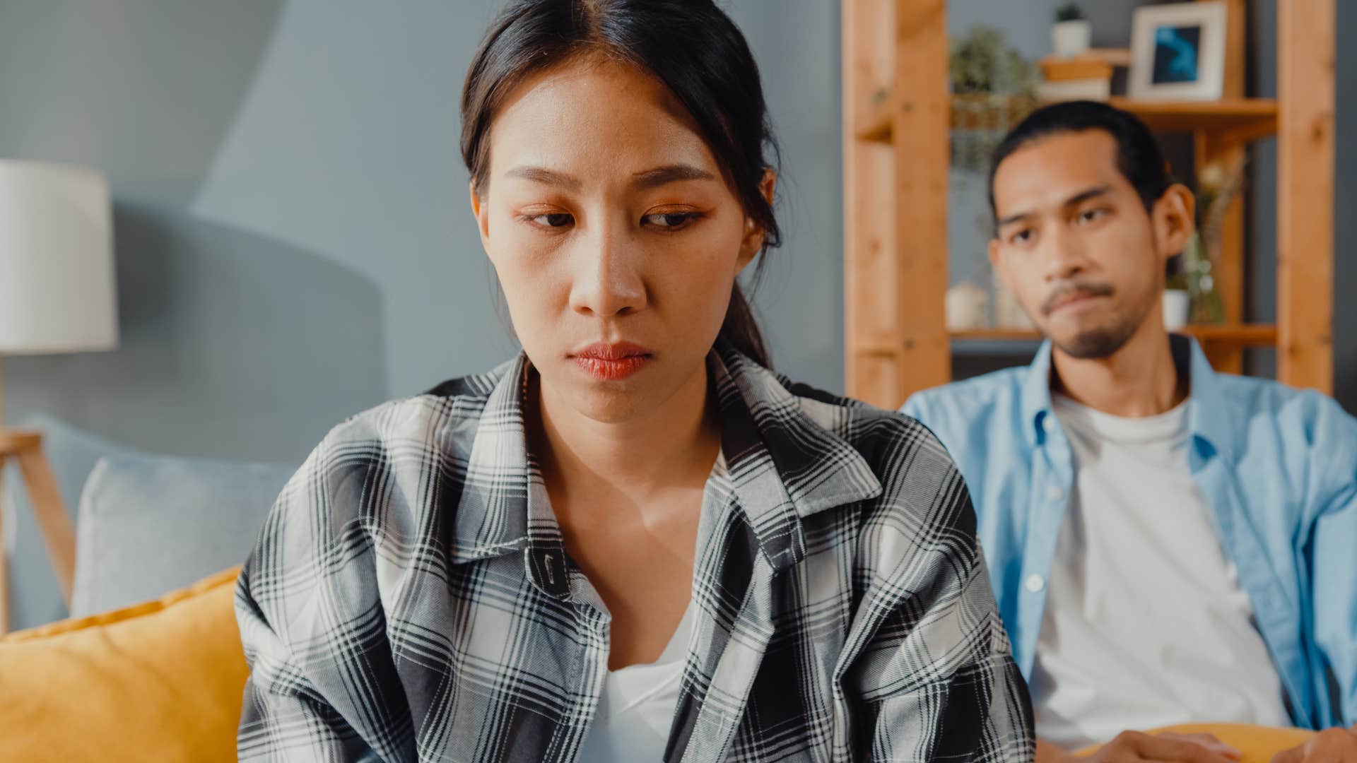 woman stonewalling husband turned away from him