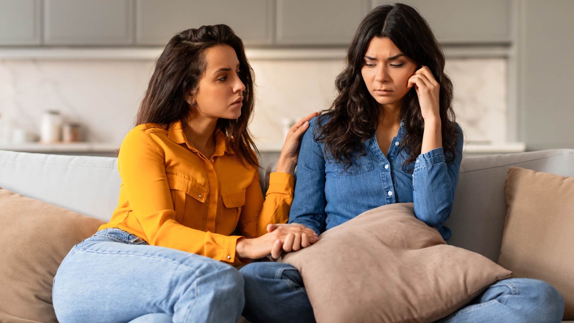 Woman saying "he just has a lot on his plate" to her friend.