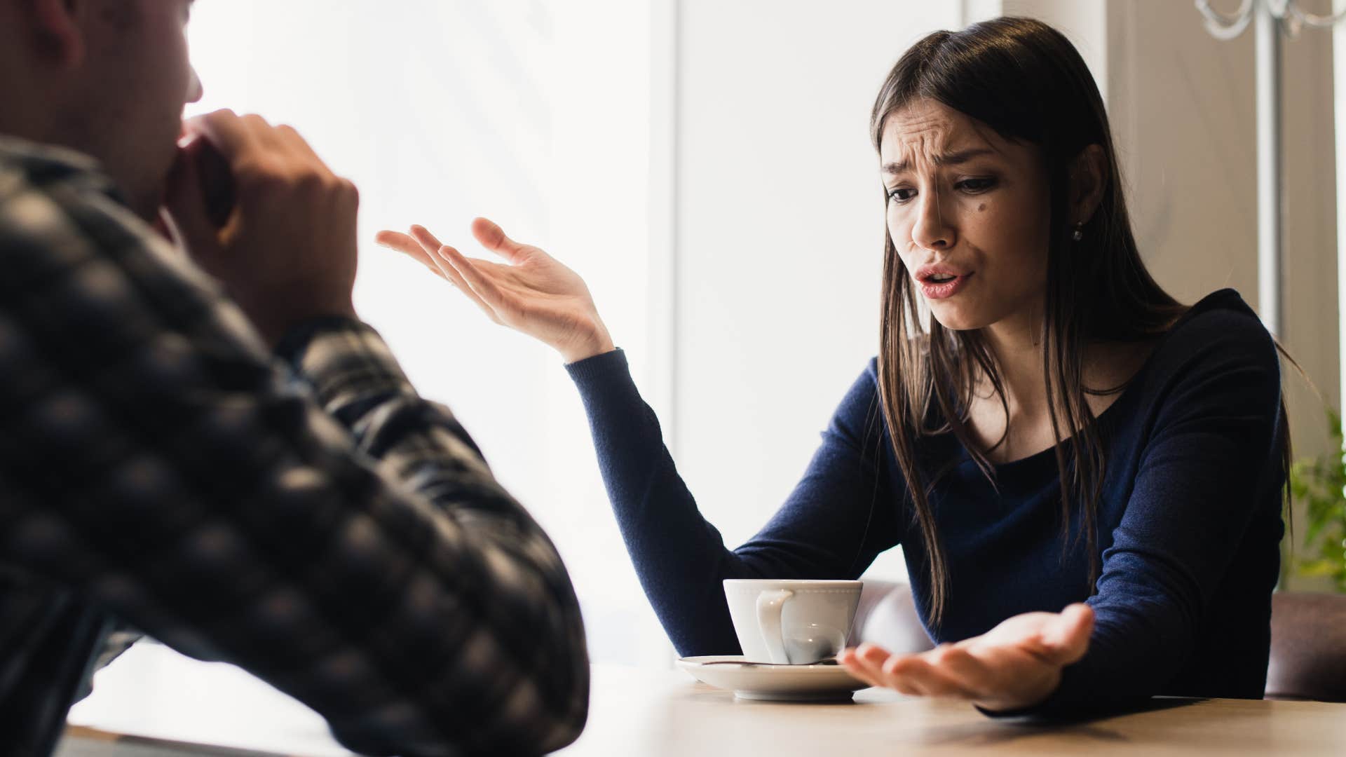 Sad woman saying "we never even fight" to a friend.