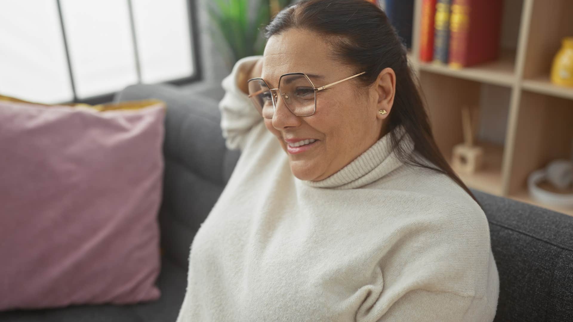 woman who's self-assured sitting on her couch