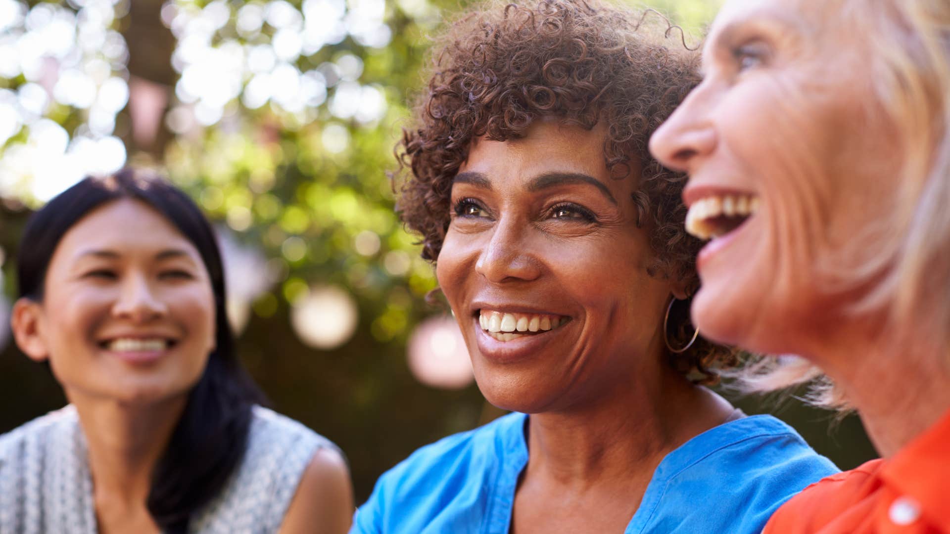 woman who has a strong relationship with others smiling with friends