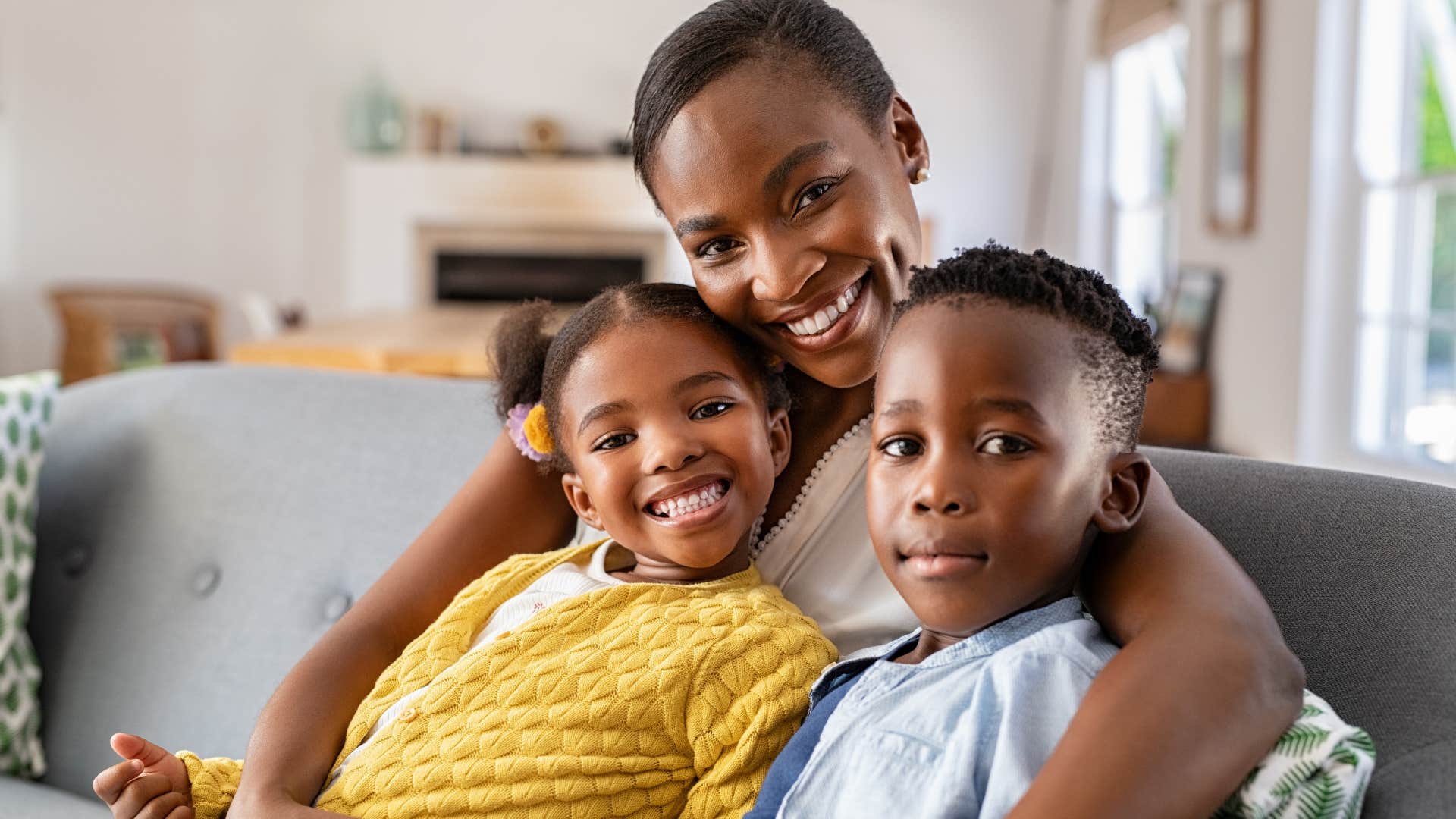 Woman who encouraged and believed in you hugging her kids.