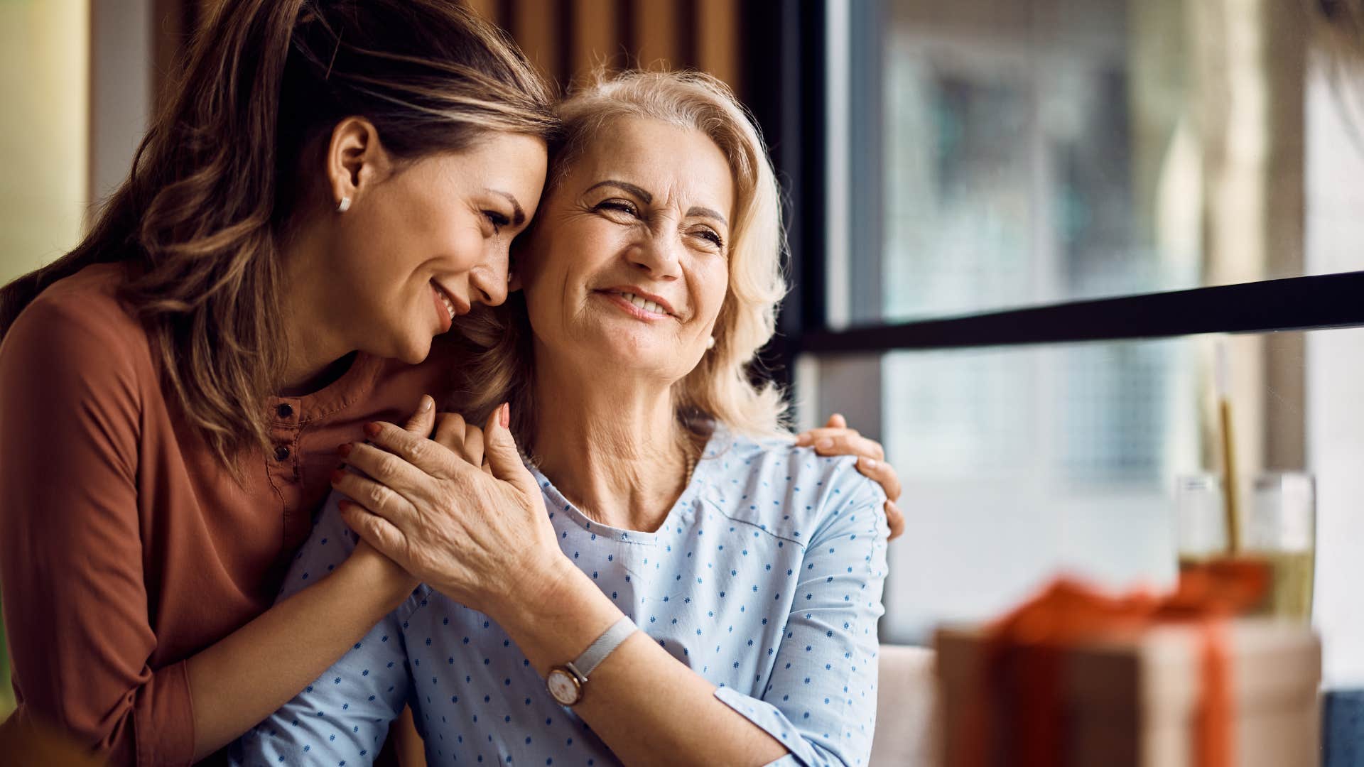 Woman who spoke positively about herself hugging her adult daughter.