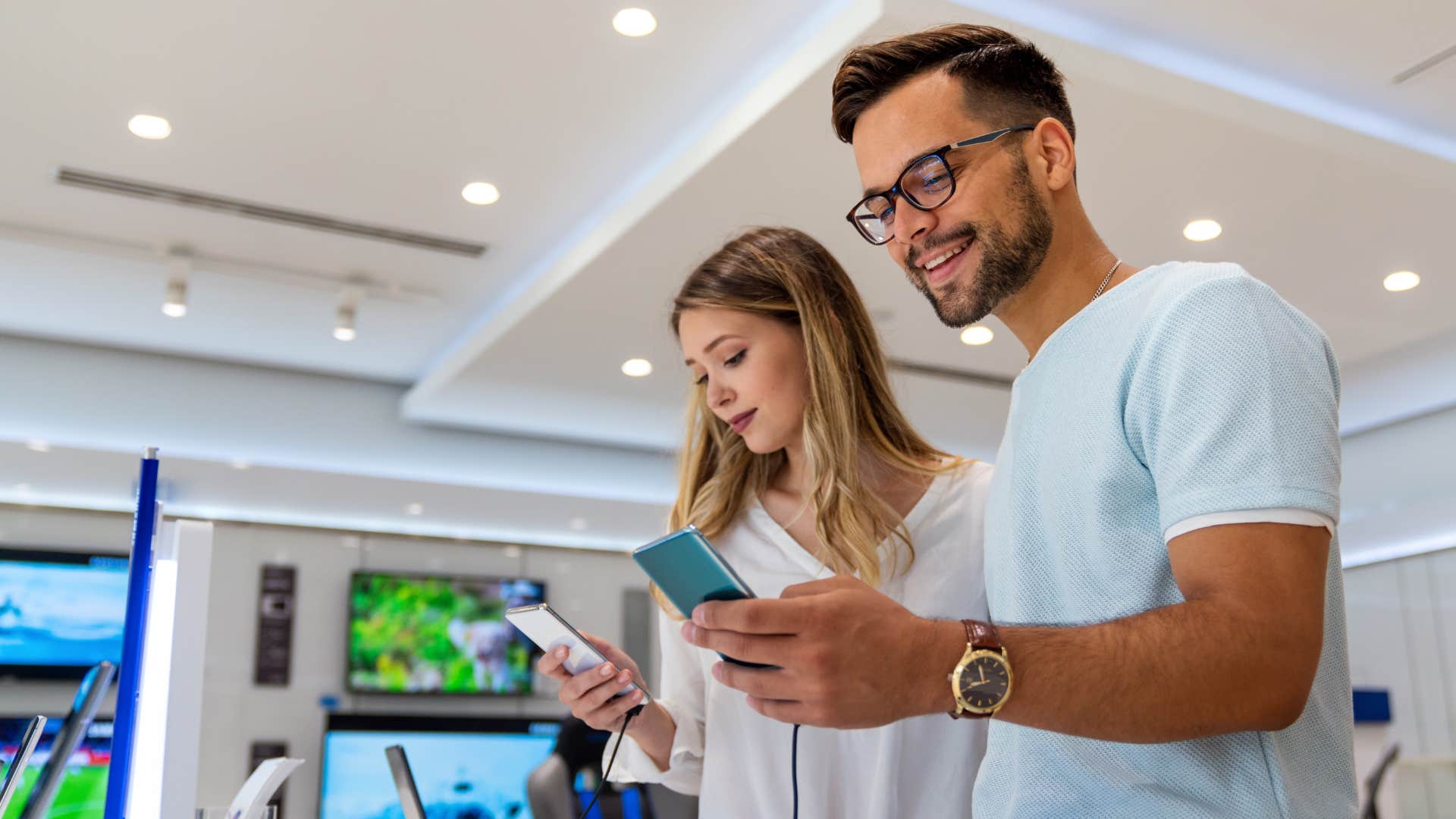Couple upgrading tech gadgets at a store.
