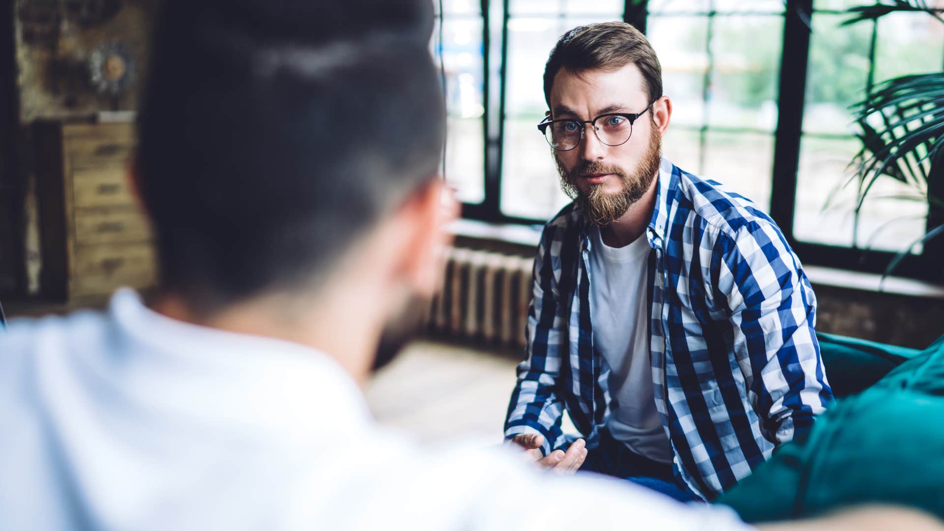 Man saying "I don't have parents to support me" to a friend.