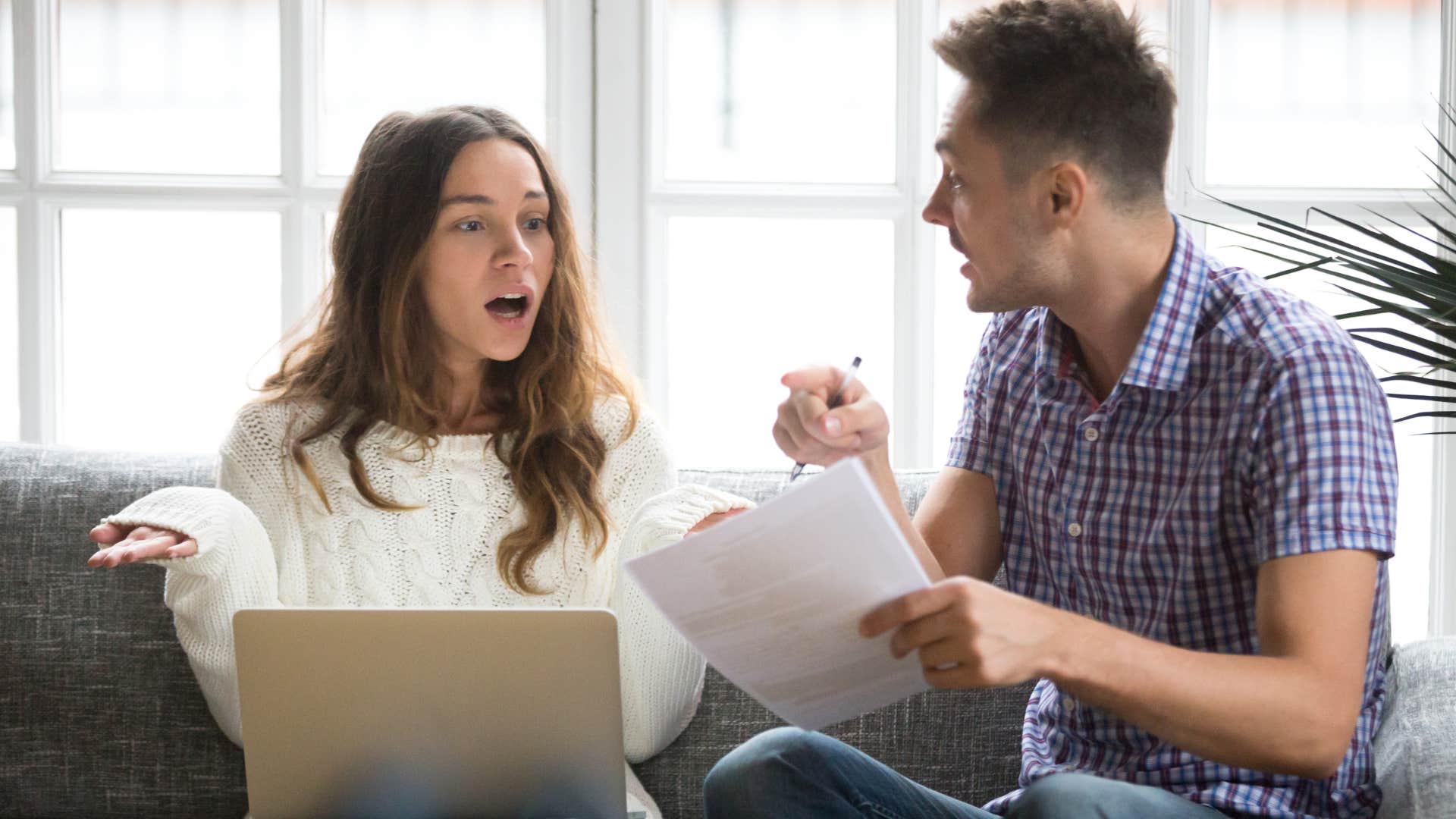 Woman saying "nobody taught me how to handle money" to her husband.