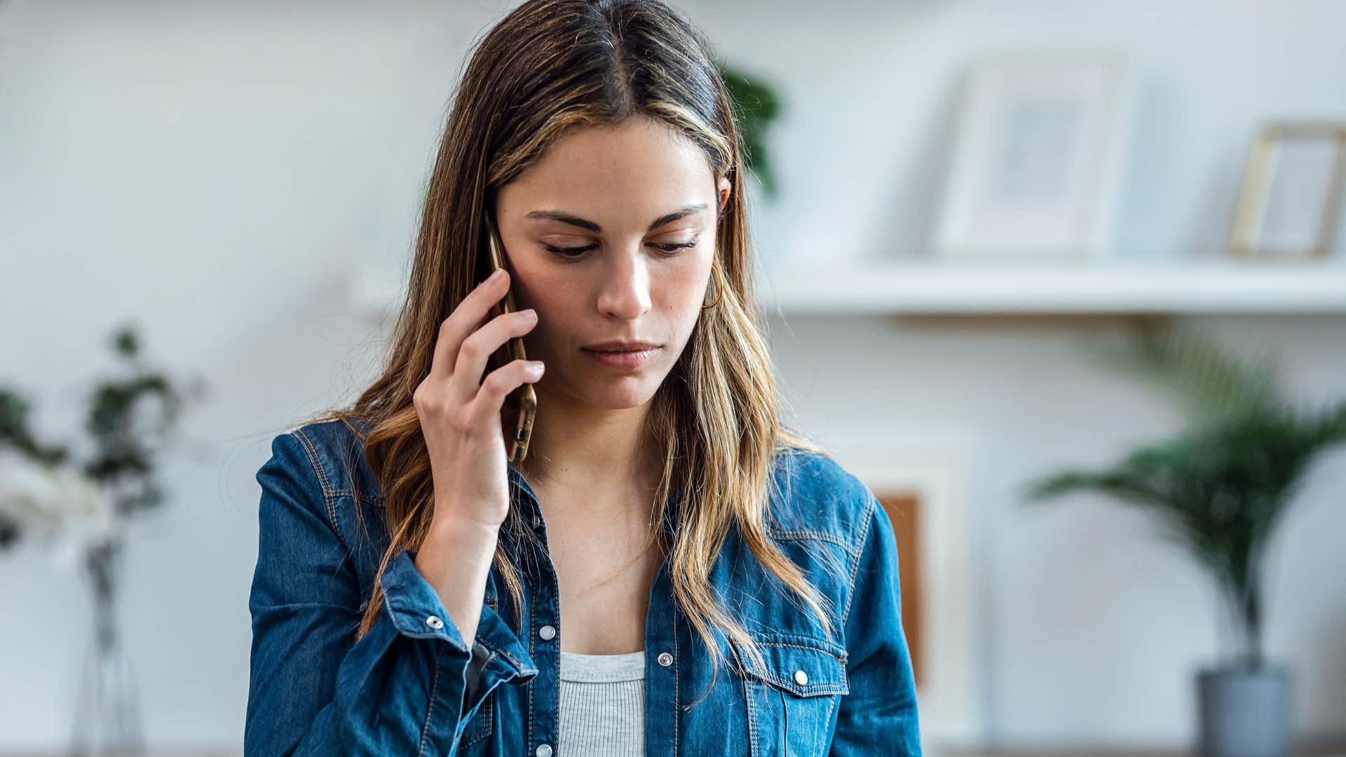 Woman saying "let's catch up another time" on the phone.