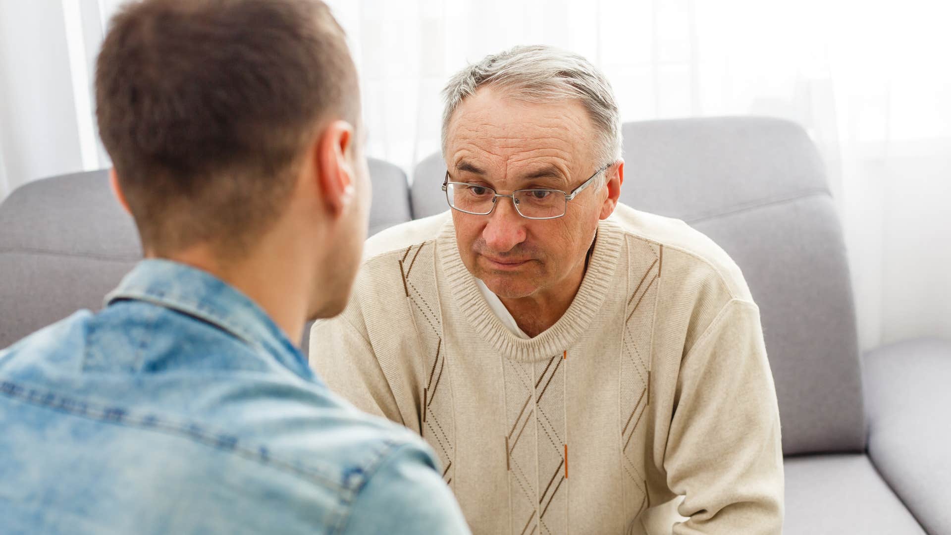Man saying "thanks, I'll keep that in mind" to his dad.
