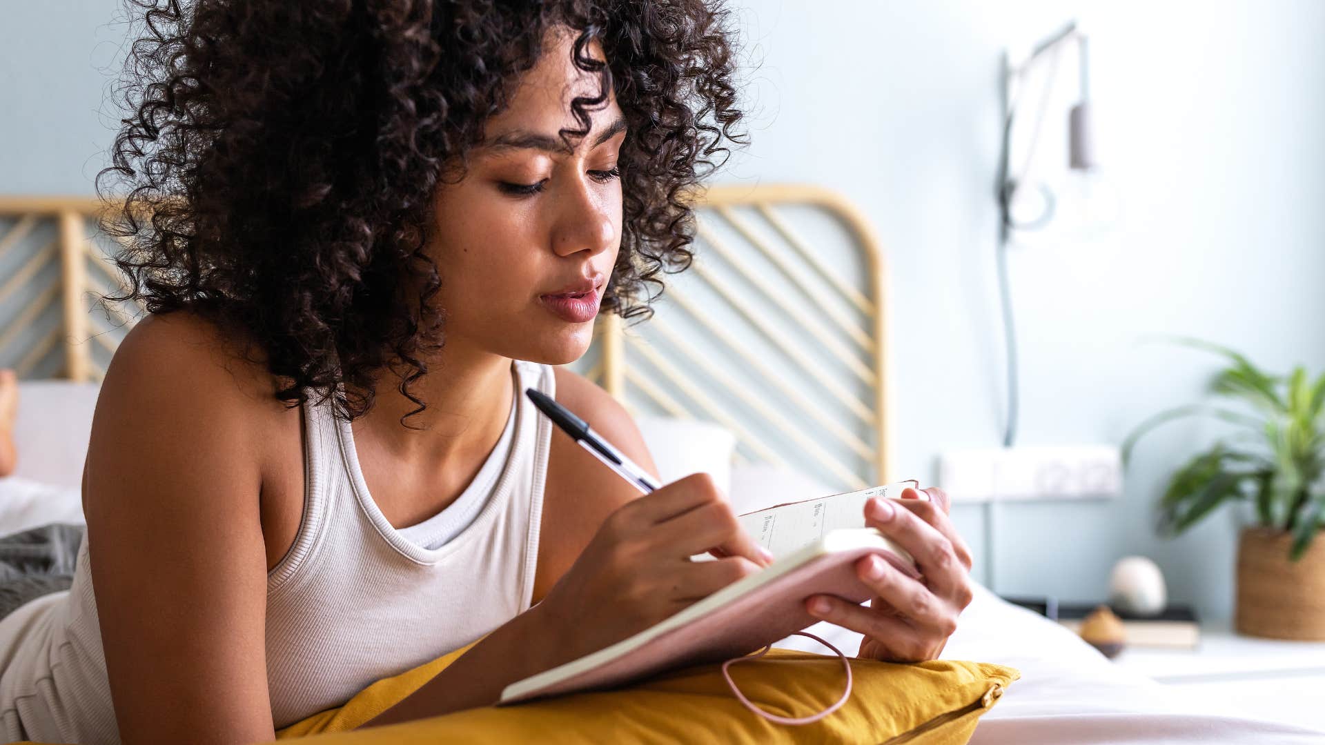 Woman making a list to get over her breakup quickly 