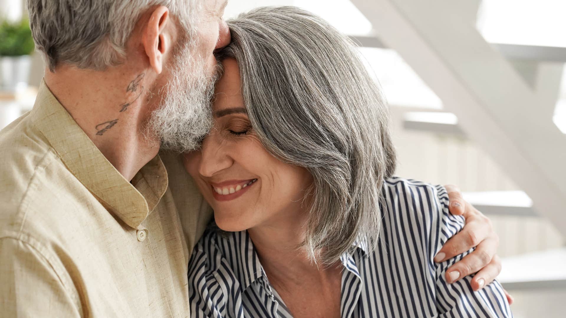 man kissing wife checking in with her