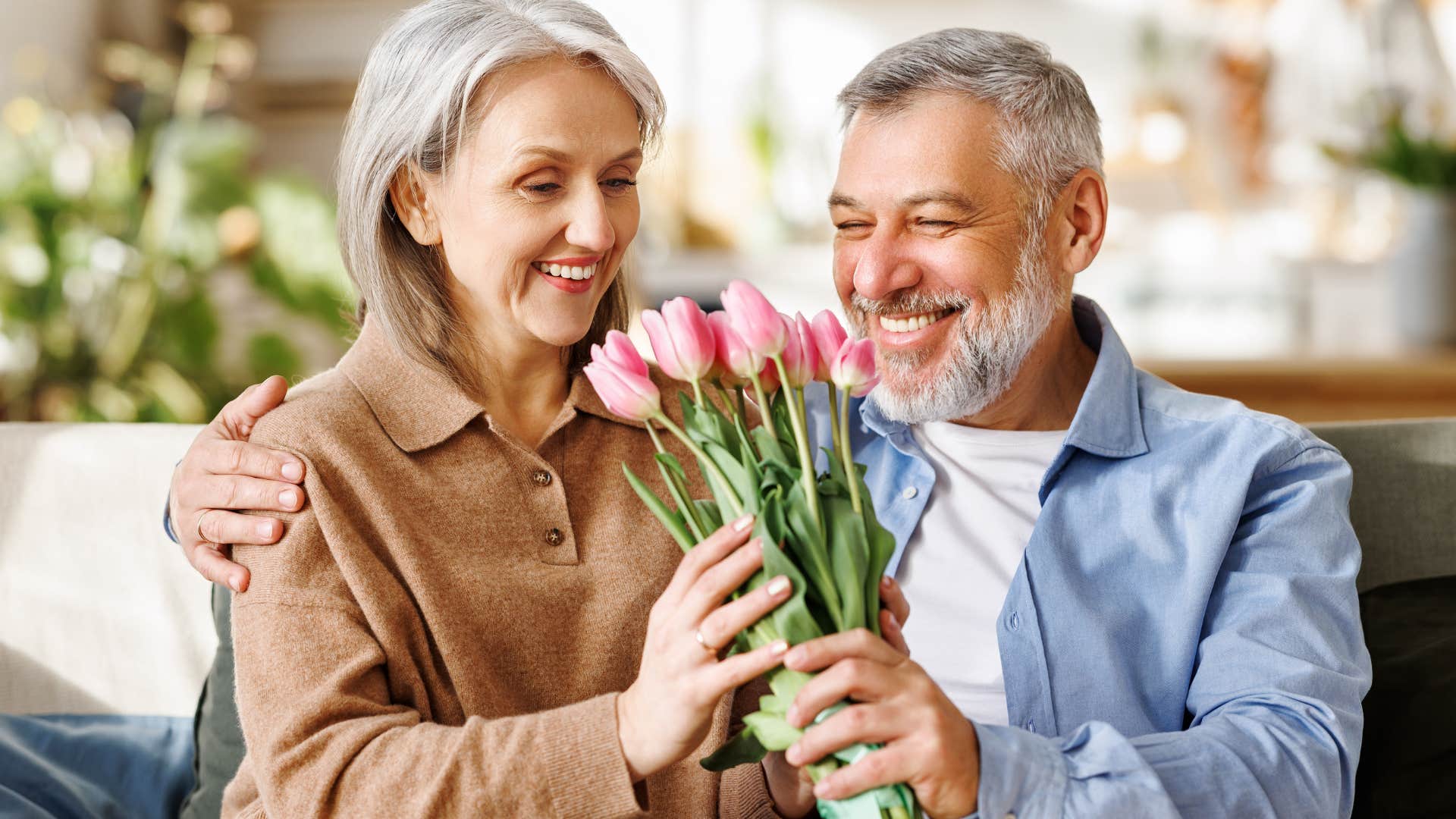 man giving his wife flowers in a vulnerable moment