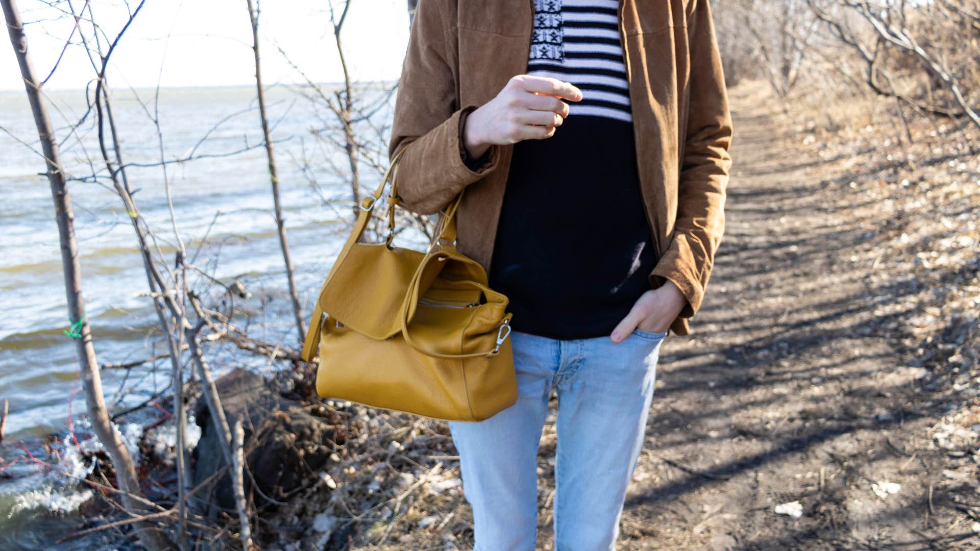 man who feels emasculated as he holds a purse