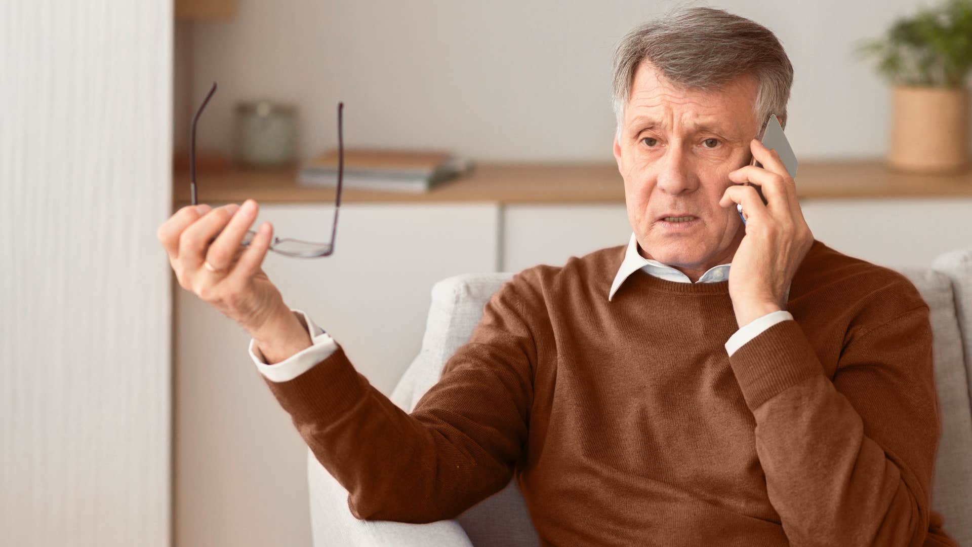 man comparing his kids to others on the phone
