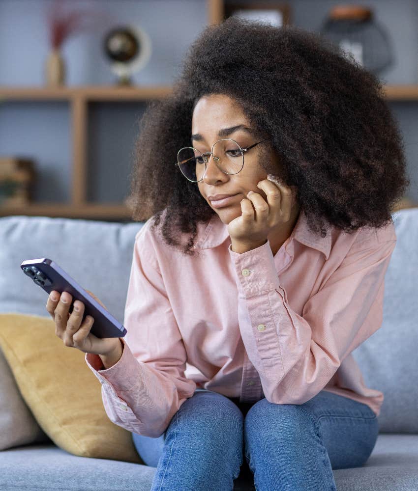 woman feeling bored scrolling on phone