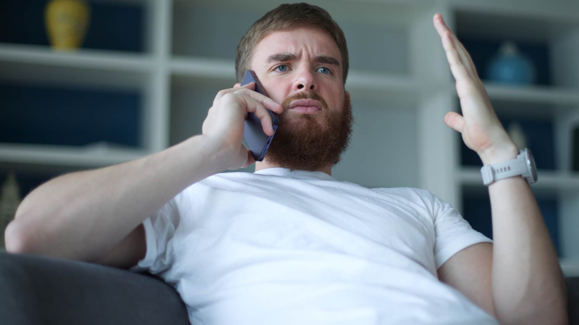 Man arguing on the phone about how feminism rejects masculinity.