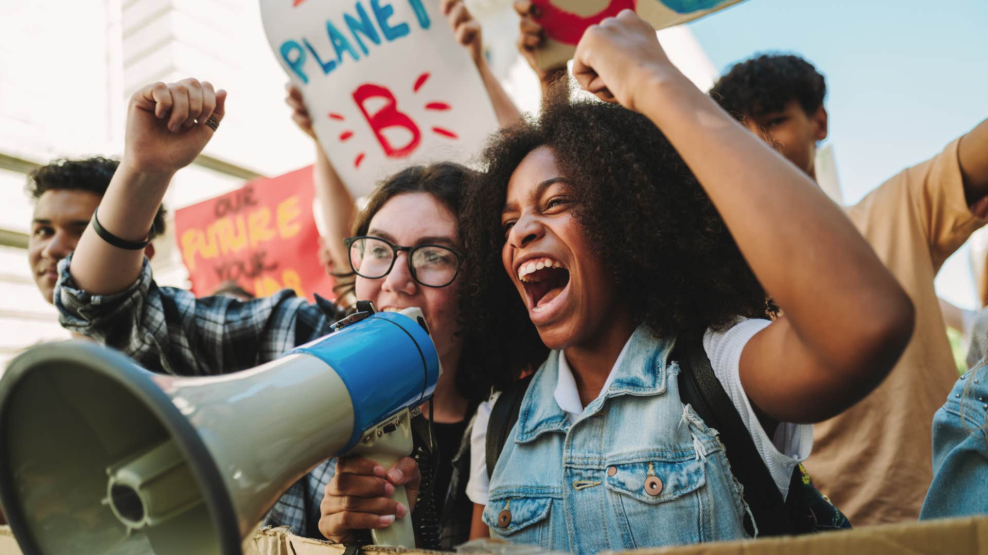 Woman marching for climate change outside.