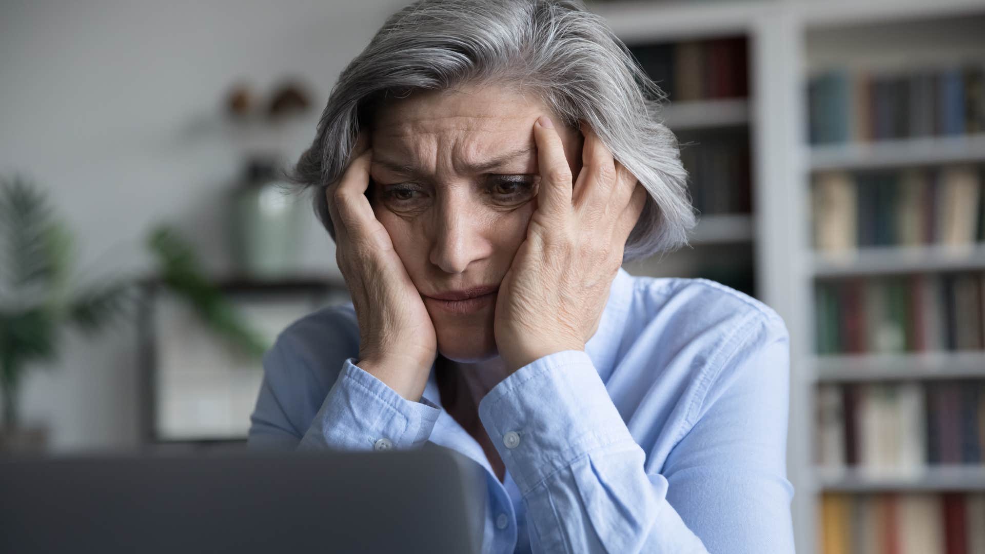 Woman thinking about remote work in the office.