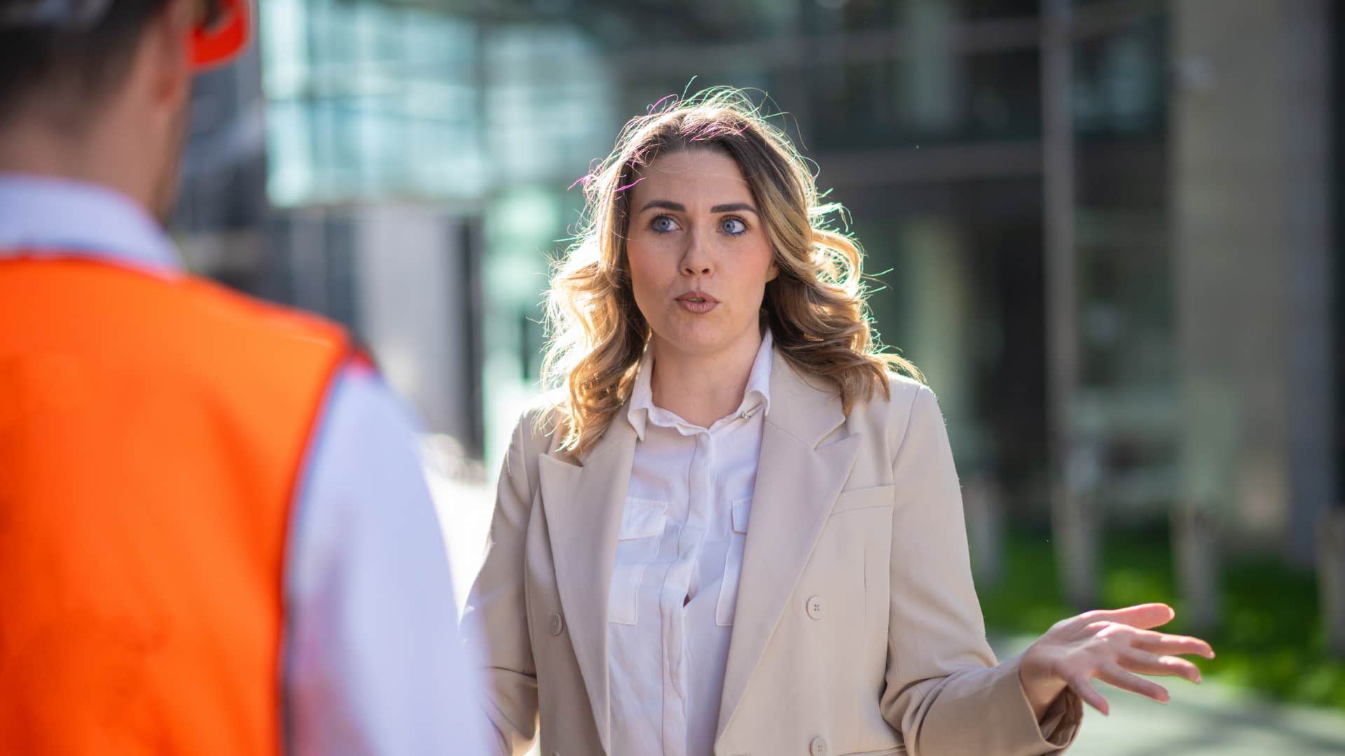 rude woman boss yelling at man outside about always working