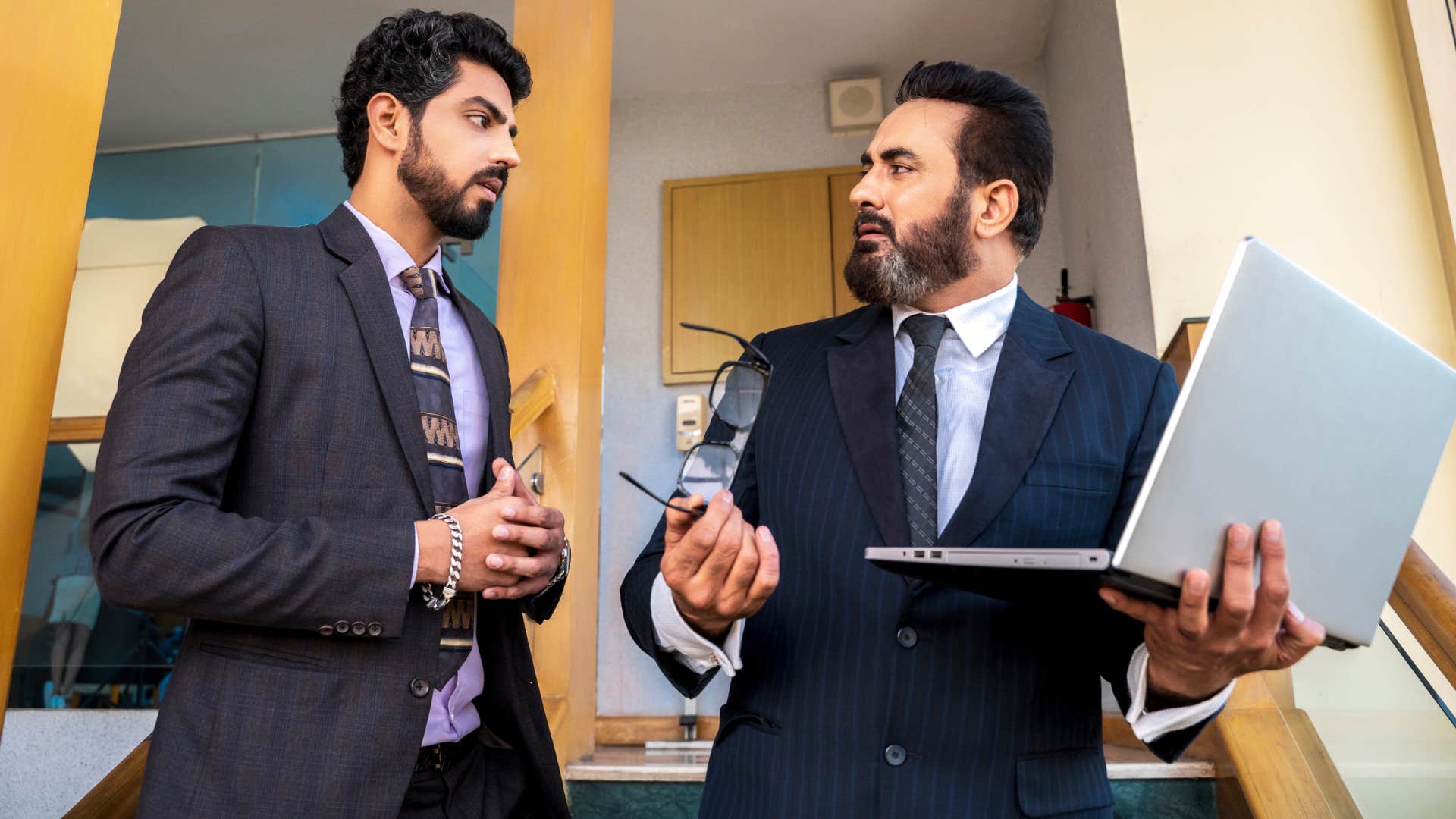 boss trying to calm employee telling him to not take it personally