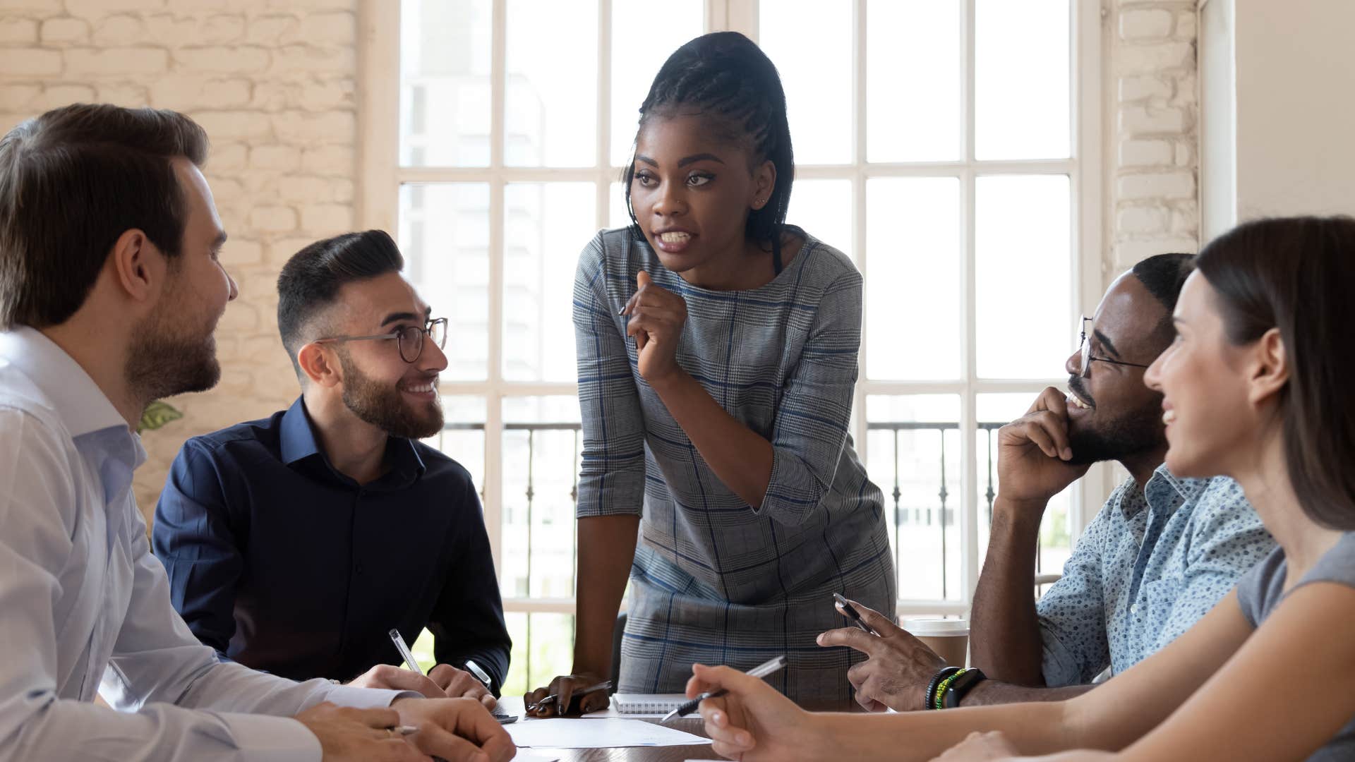 boss telling employees she needs them to be team players